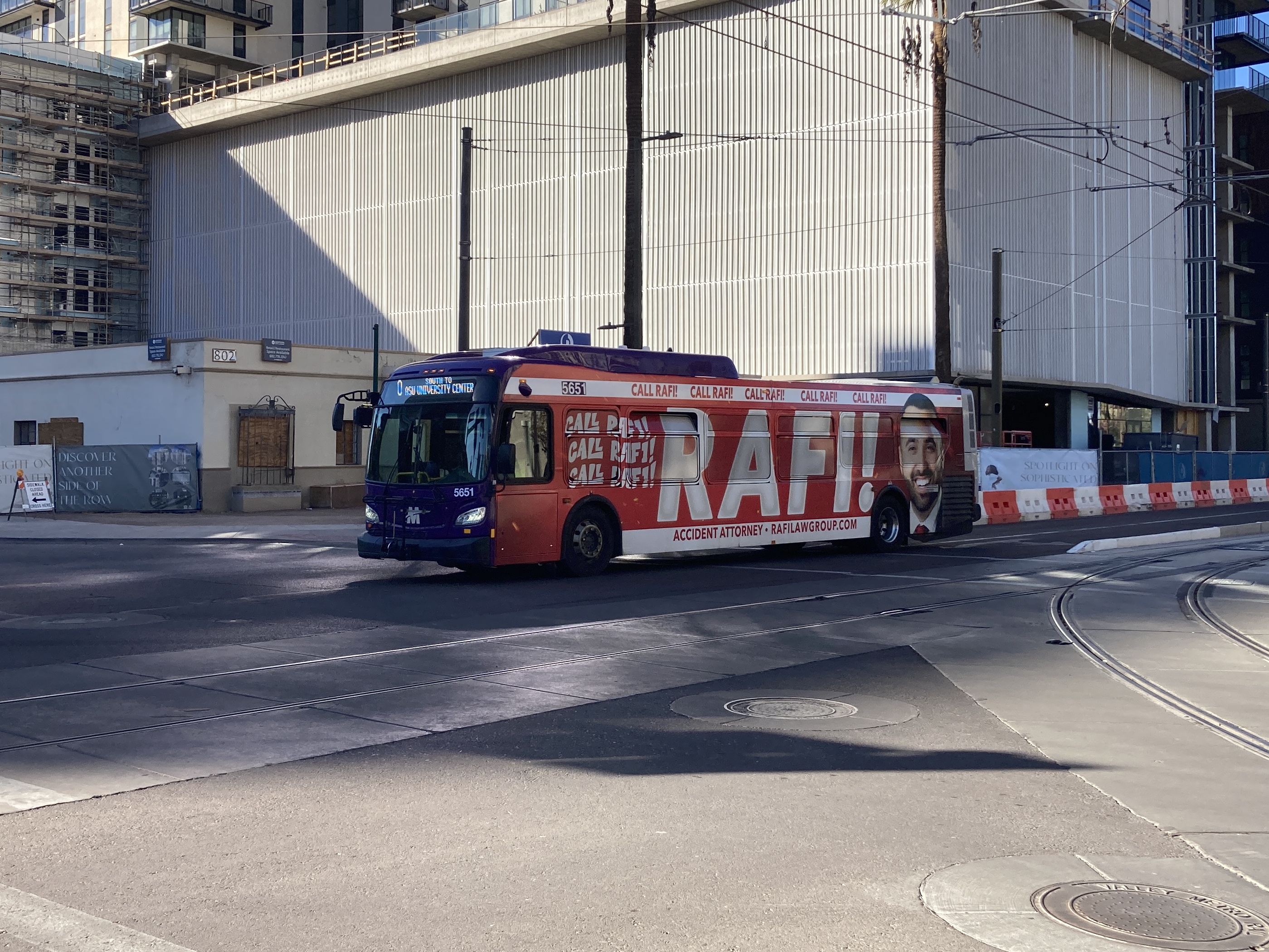 A purple Valley Metro bus, number 5651, traveling southbound on Central Avenue in Phoenix on route 0 to ASU University Center