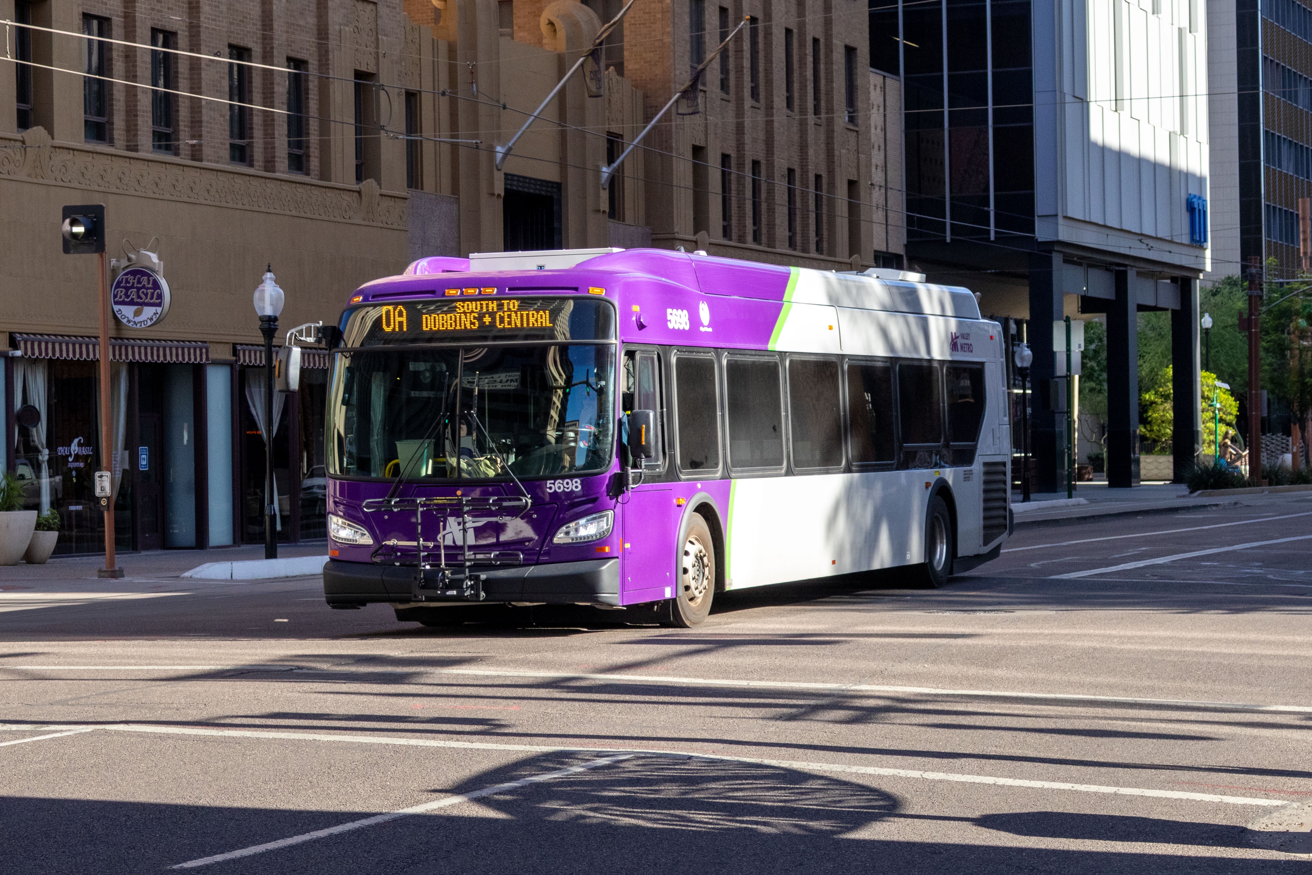 A purple and gray Valley Metro bus, number 5698, traveling southbound on 1st Avenue in Phoenix on route 0A to Dobbins and Central