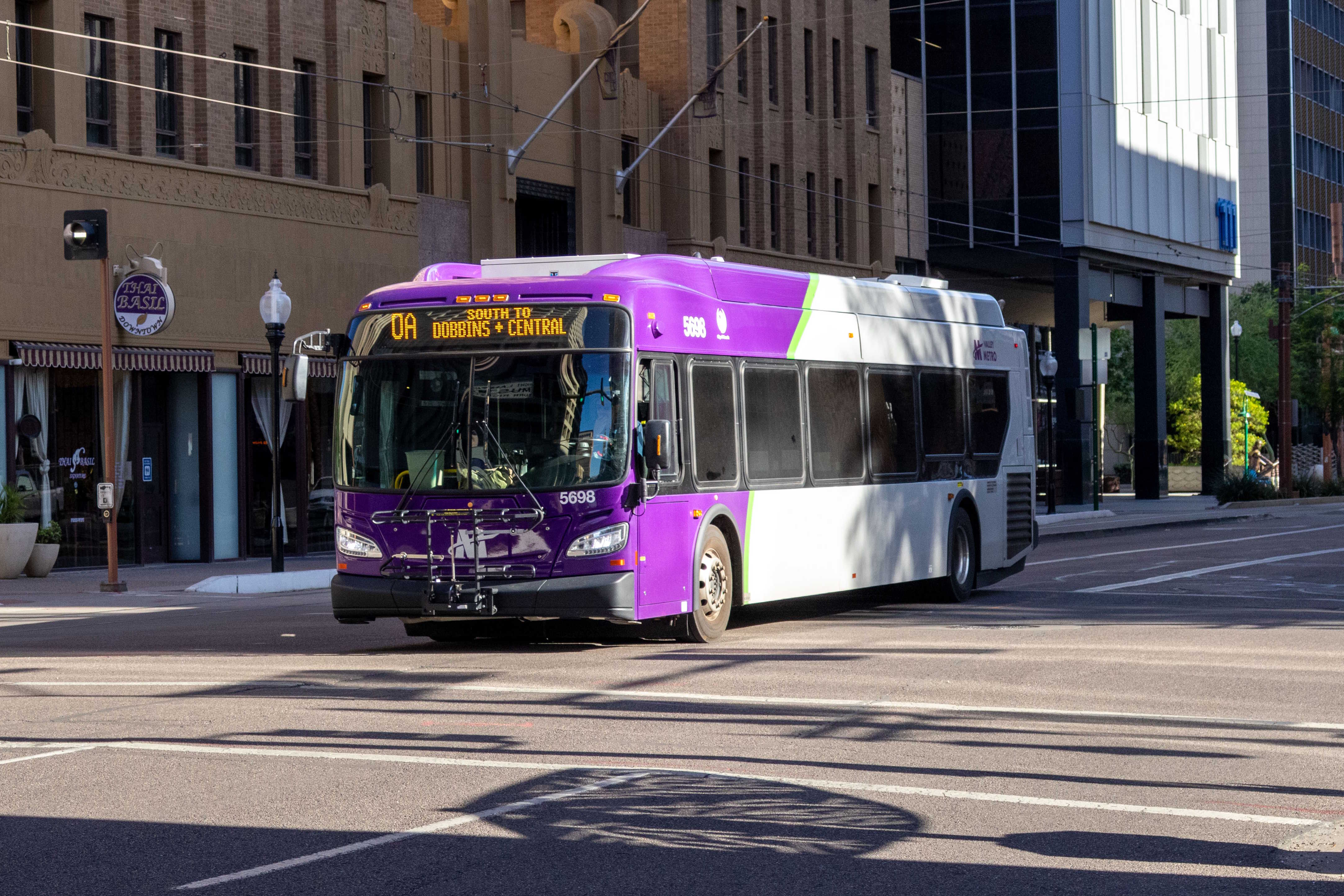 A purple and gray Valley Metro bus, number 5698, traveling southbound on 1st Avenue in Phoenix on route 0A to Dobbins and Central