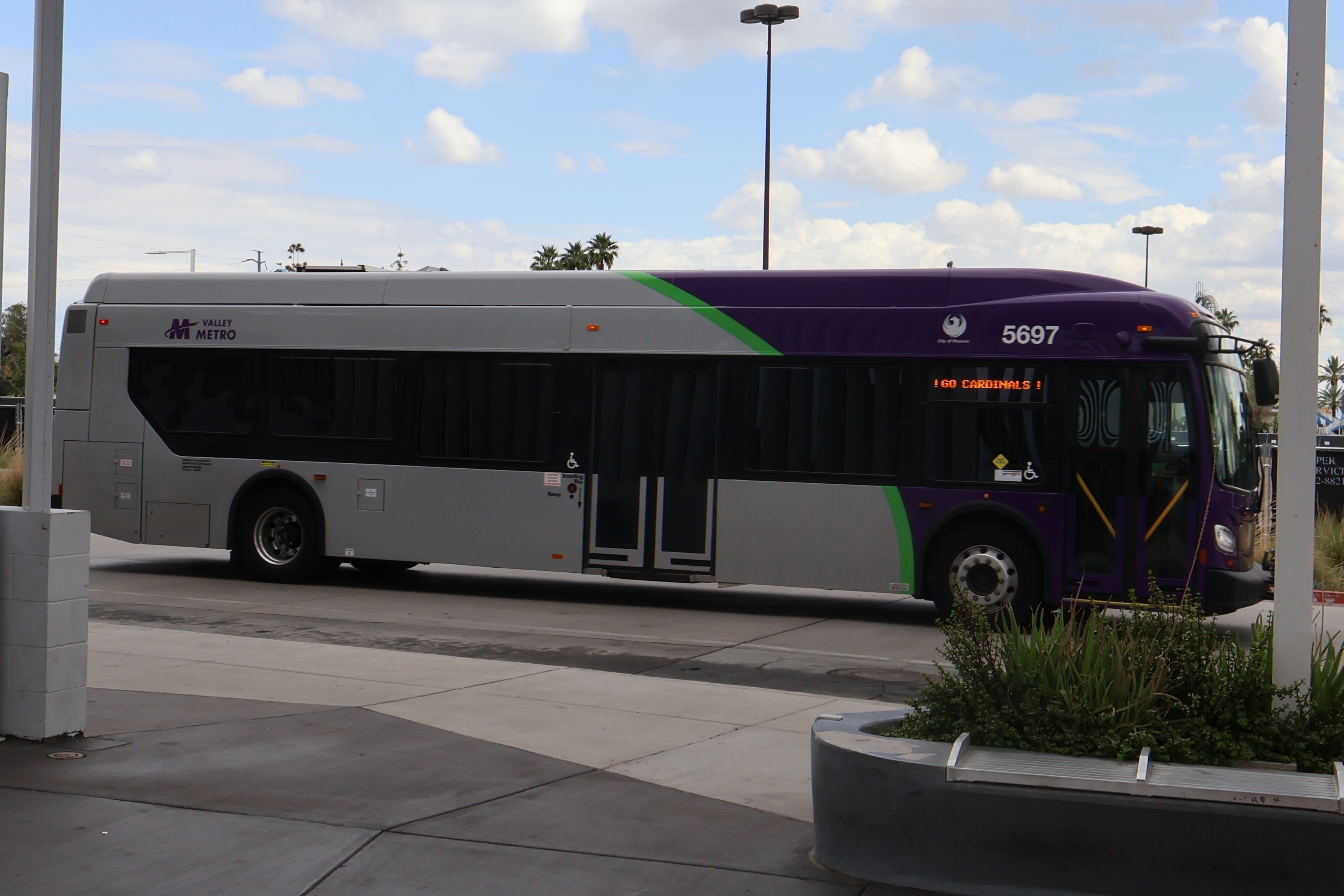 A purple and gray Valley Metro bus, number 5697, at Thelda Williams Transit Center in Phoenix on route 106 to Santa Fe Drive and 105th Avenue