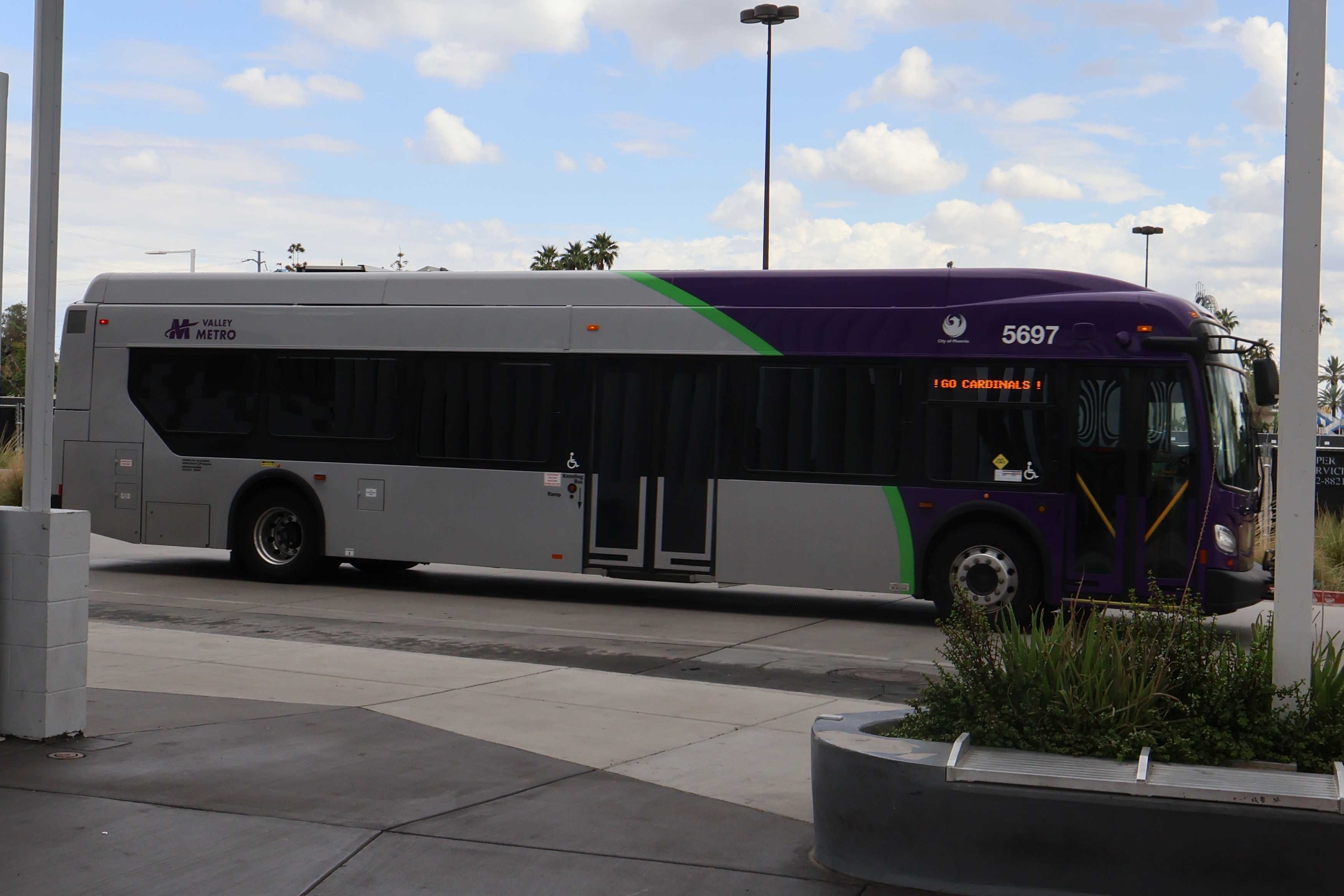 A purple and gray Valley Metro bus, number 5697, at Thelda Williams Transit Center in Phoenix on route 106 to Santa Fe Drive and 105th Avenue