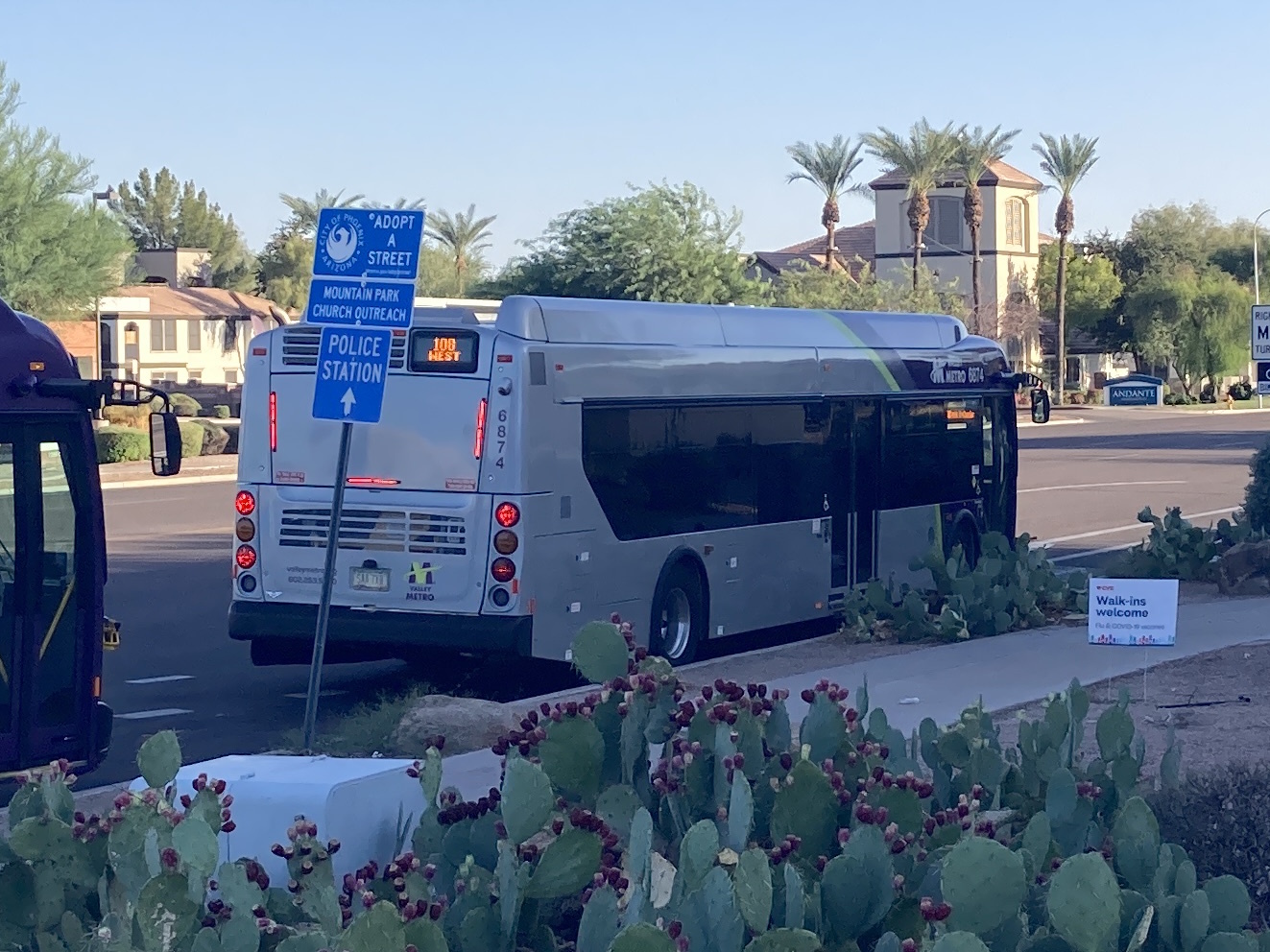 A gray and purple Valley Metro bus, with a green stripe, number 6874, traveling southbound on 48th Street in Phoenix on route 108 to 48th Street and Chandler Boulevard