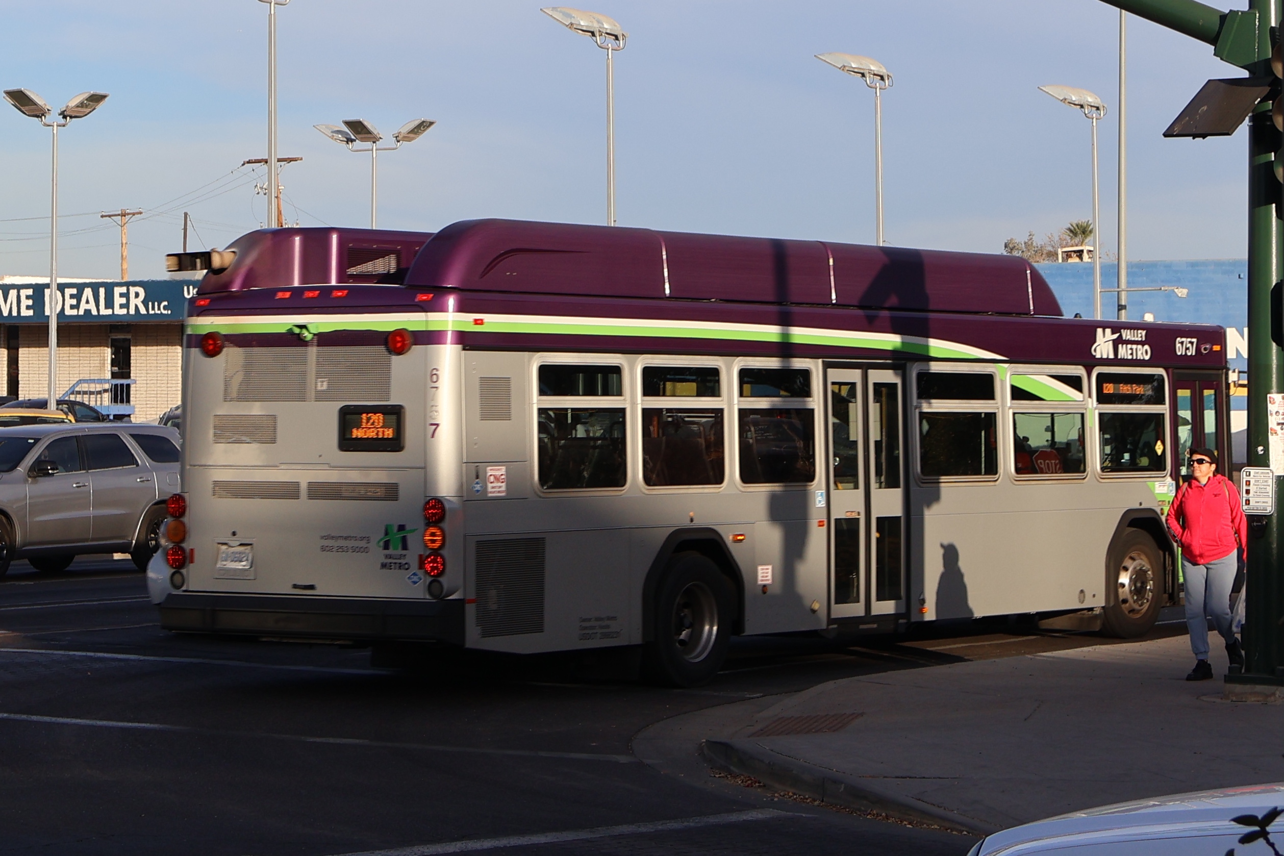 A gray and purple Valley Metro bus with a white and green stripe, number 6757, traveling northbound on Mesa Drive in Mesa on route 120 to Fitch Park