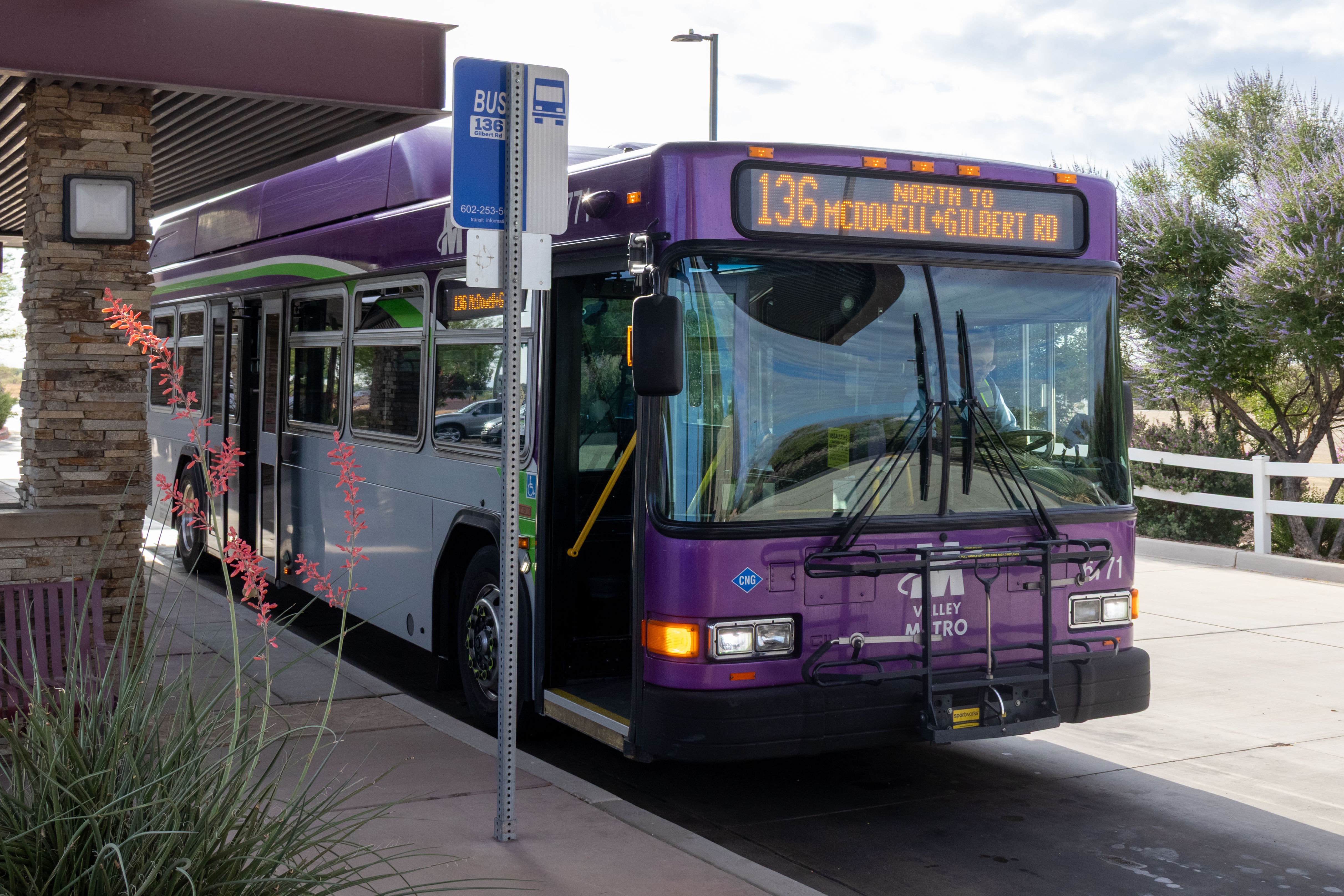 A gray and purple Valley Metro bus, with a white and green stripe, number 6771, at Gilbert Road and McDowell Road Park and Ride in Mesa on route 136 to Gilbert Road and McDowell Road