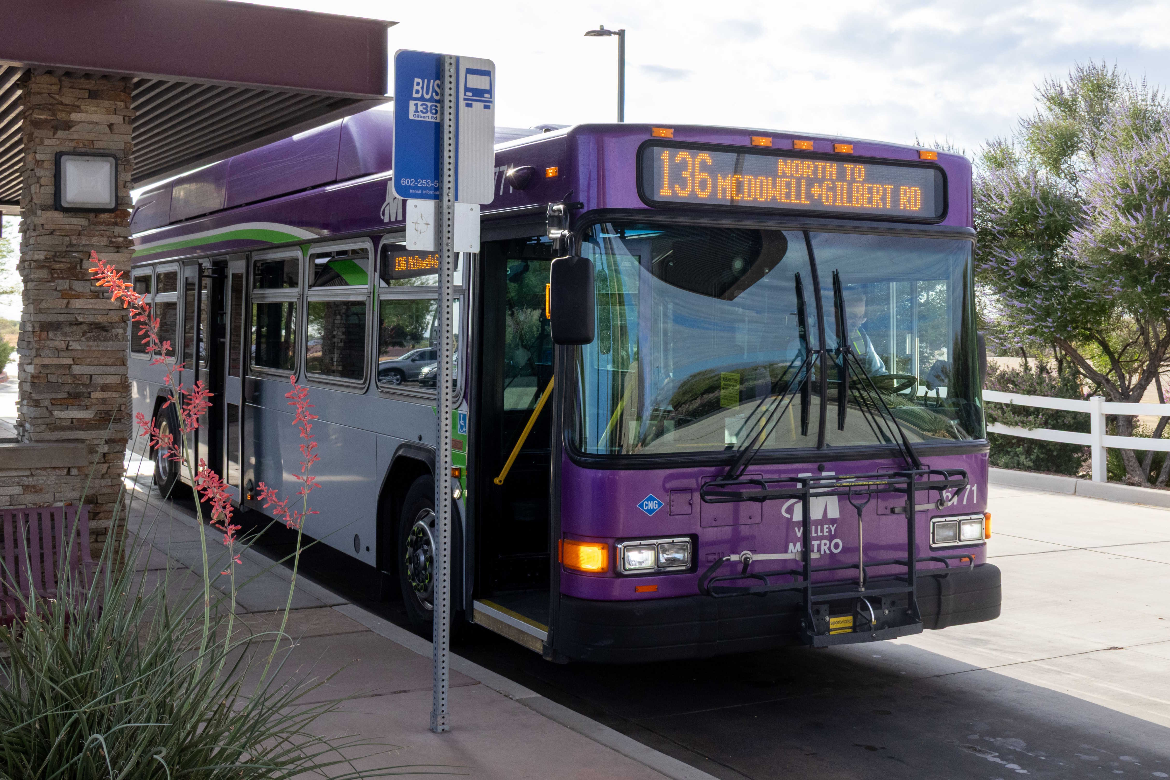 A gray and purple Valley Metro bus, with a white and green stripe, number 6771, at Gilbert Road and McDowell Road Park and Ride in Mesa on route 136 to Gilbert Road and McDowell Road