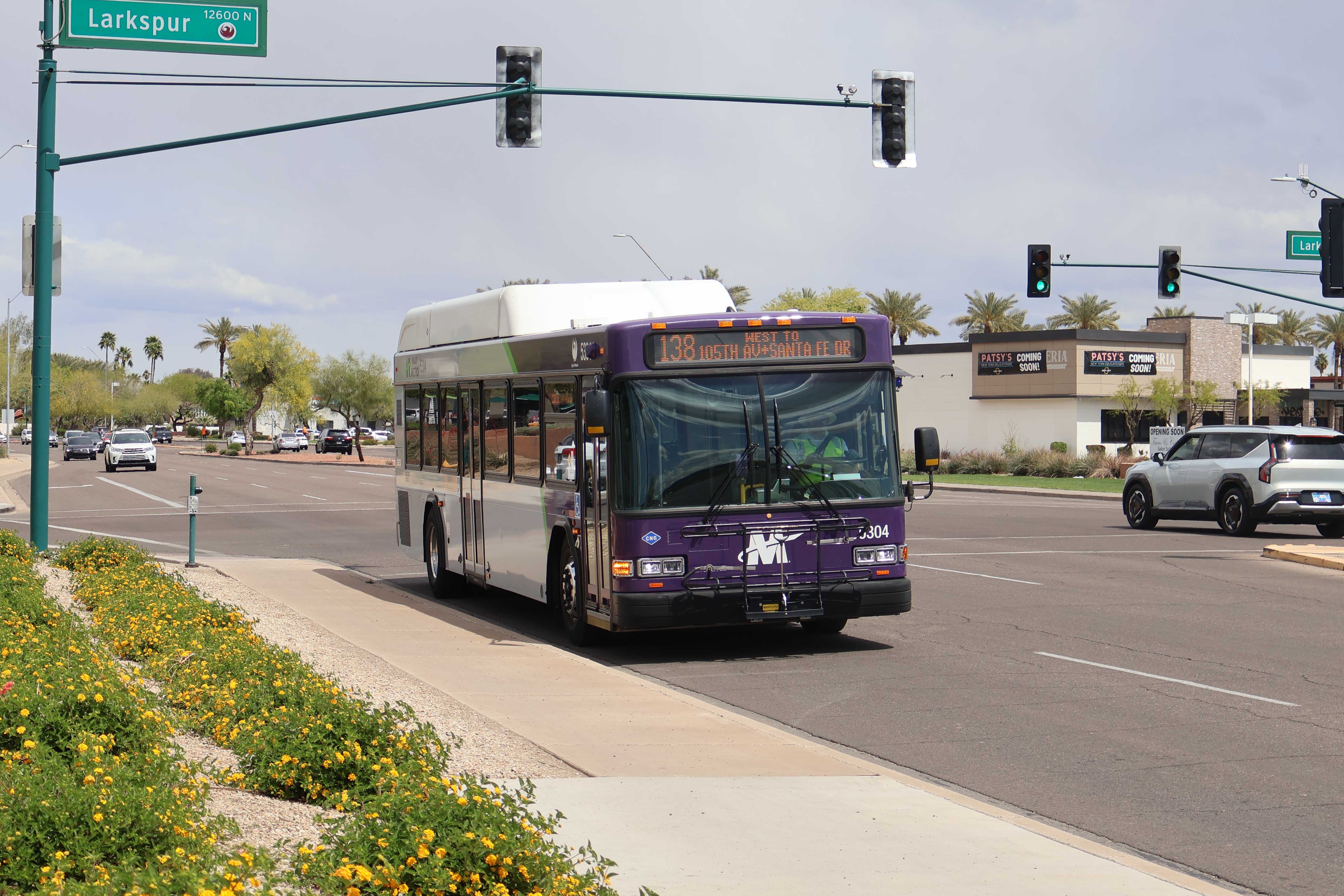 A purple and gray Valley Metro bus, number 5304, traveling southbound on Tatum Boulevard in Phoenix on route 138 to Santa Fe Drive and 105th Drive