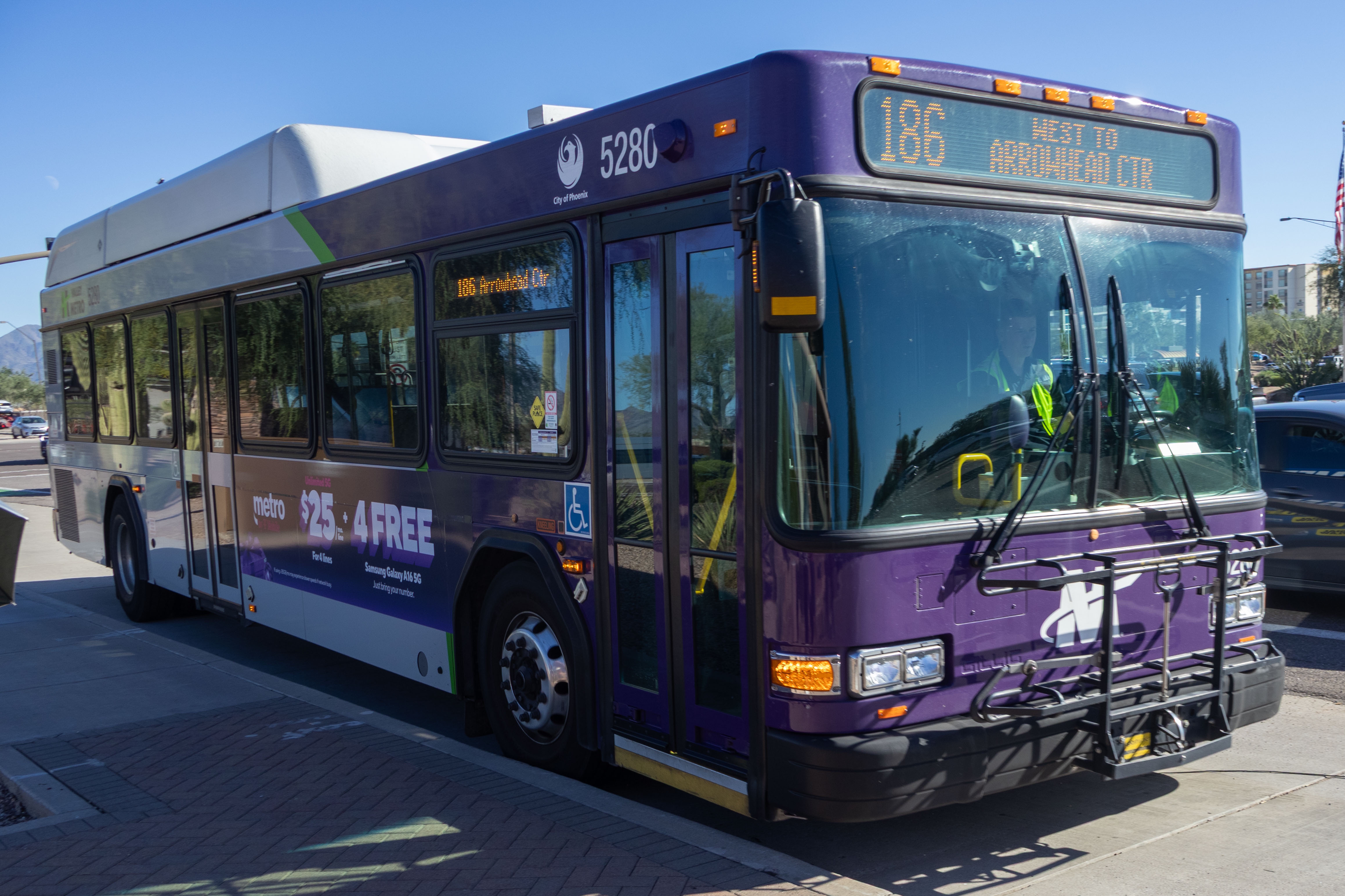 A purple and gray Valley Metro bus, number 5280, traveling westbound on Mayo Boulevard in Phoenix on route 186 to Arrowhead Mall Transit Center