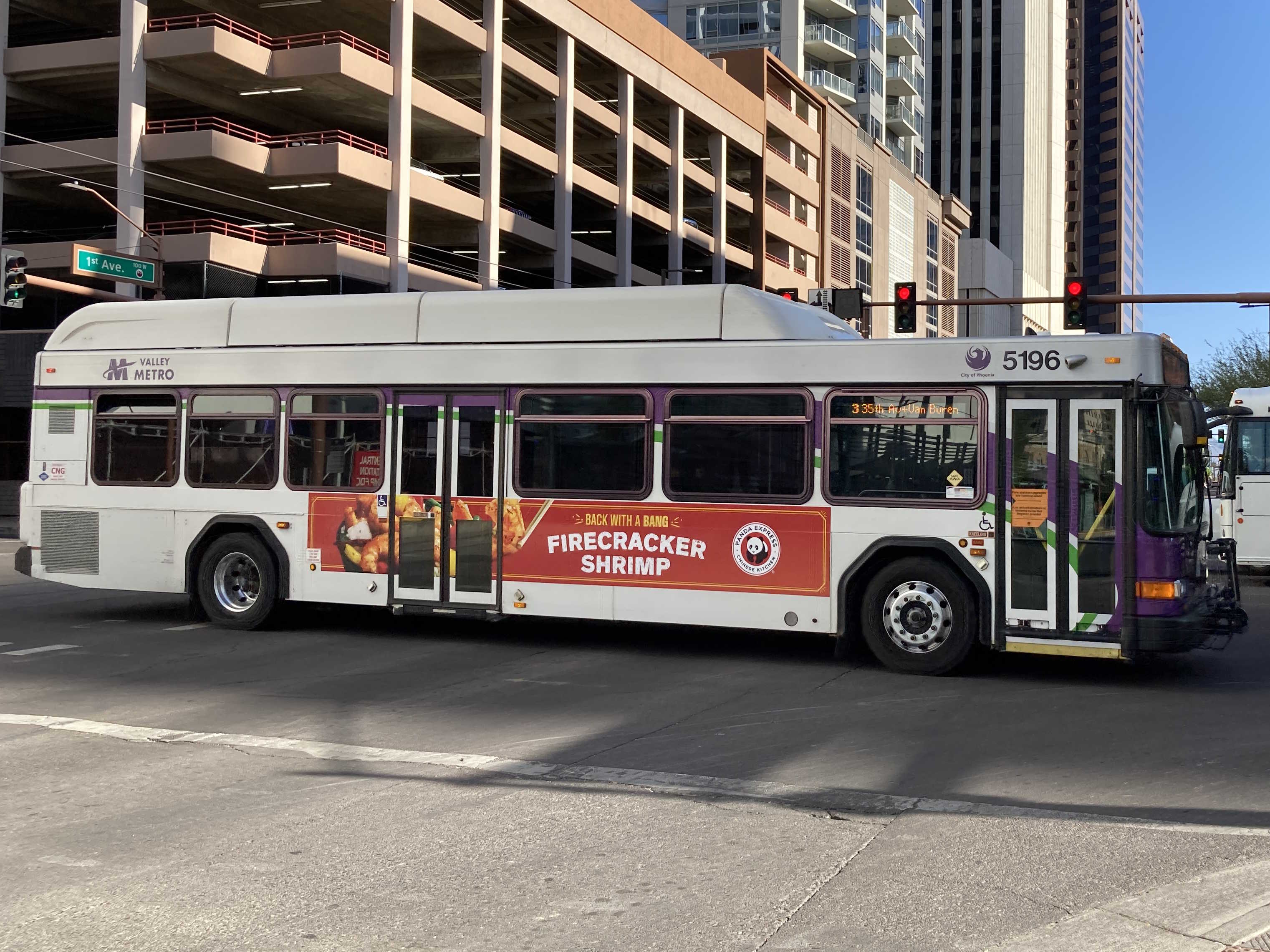 A white and gray Valley Metro bus, with purple and green accent colors, number 5247, traveling westbound on Van Buren Street in Phoenix on route 3 to 35th Avenue and Van Buren