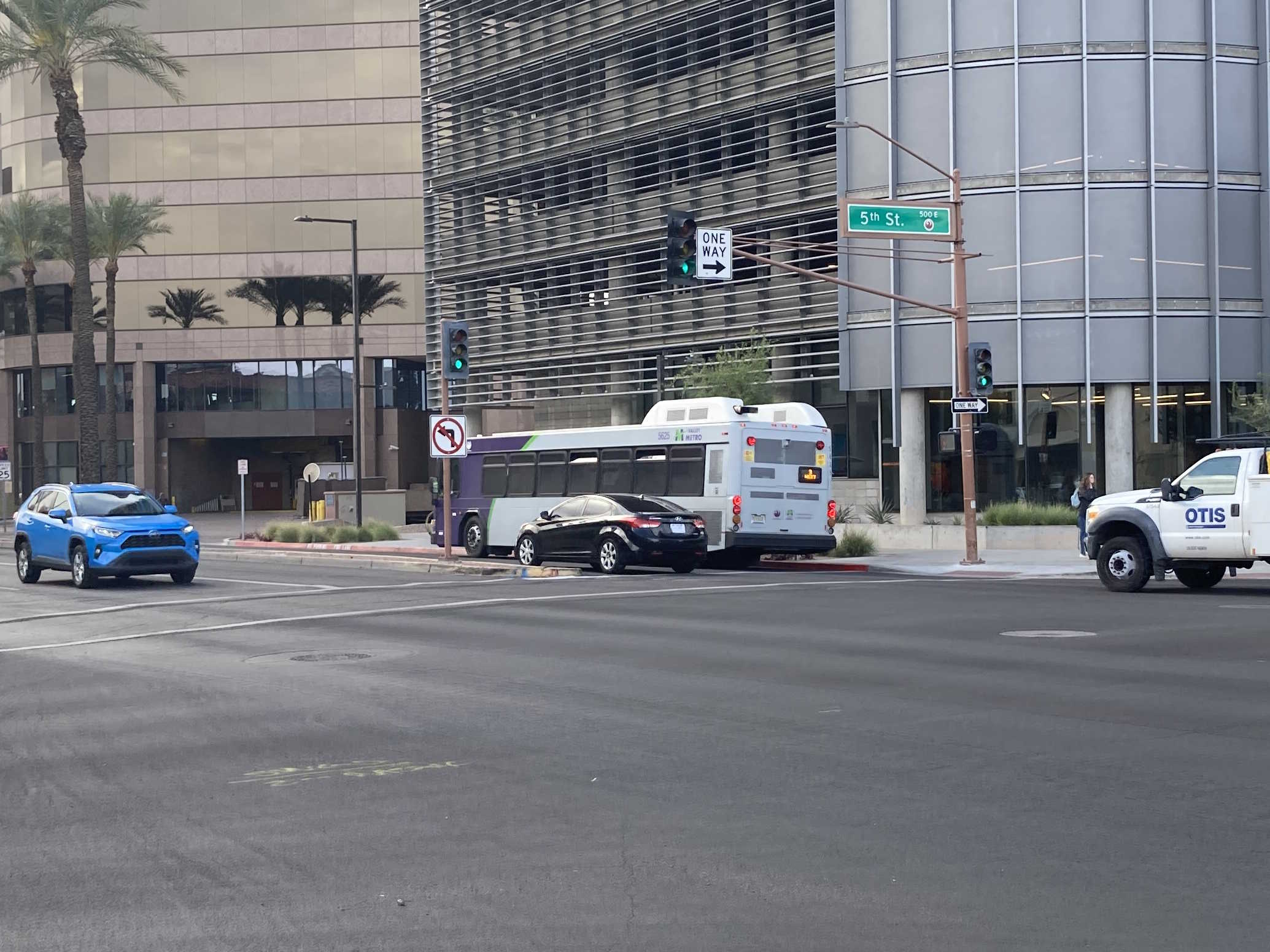 A purple and gray Valley Metro bus, number 5625, traveling westbound on Van Buren Street in Phoenix on route 3 to 4th Street and La Canada Boulevard