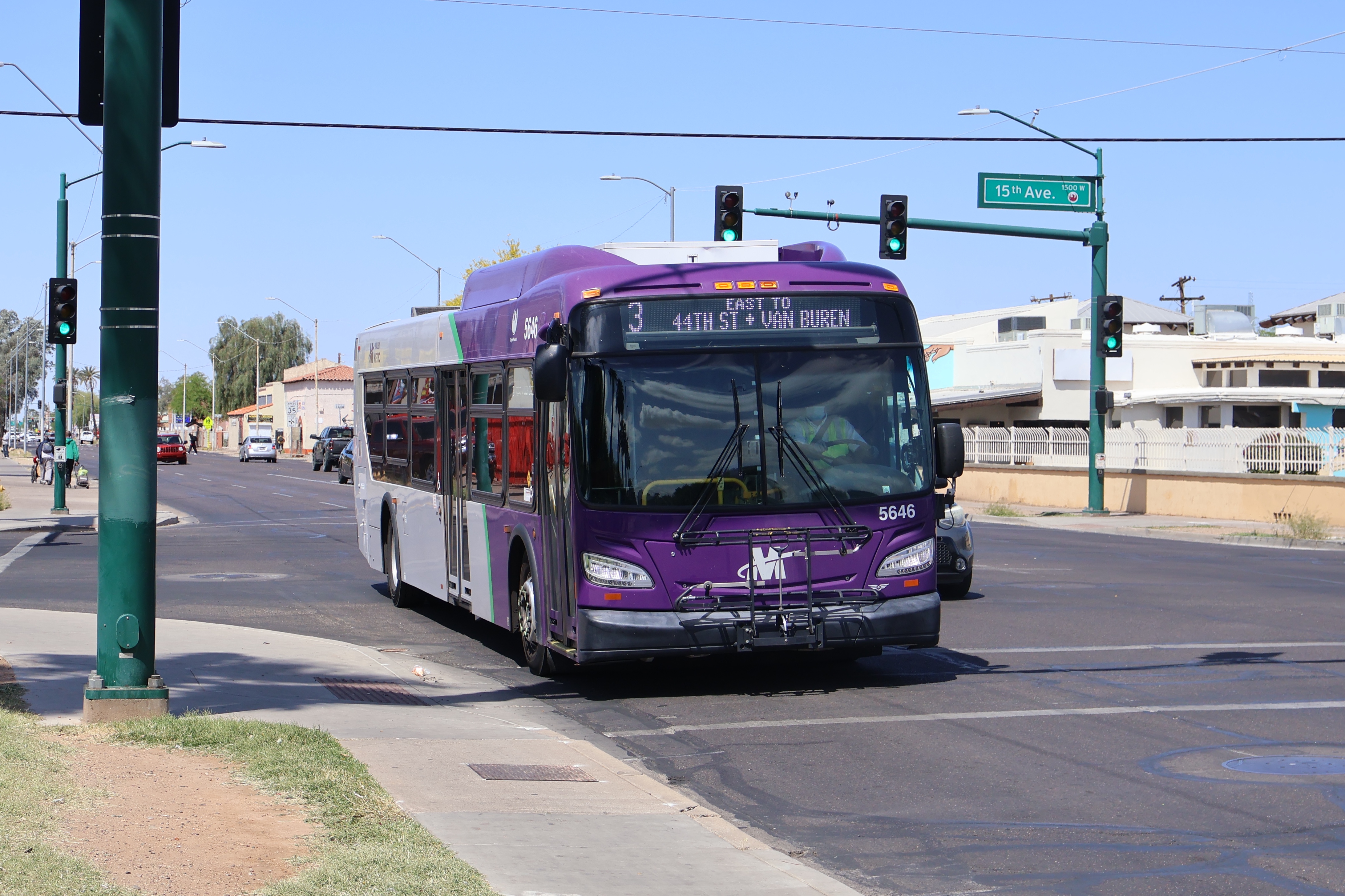 A purple and gray Valley Metro bus, number 5646, traveling eastbound on Van Buren Street in Phoenix on route 3 to Van Buren Street and 44th Street