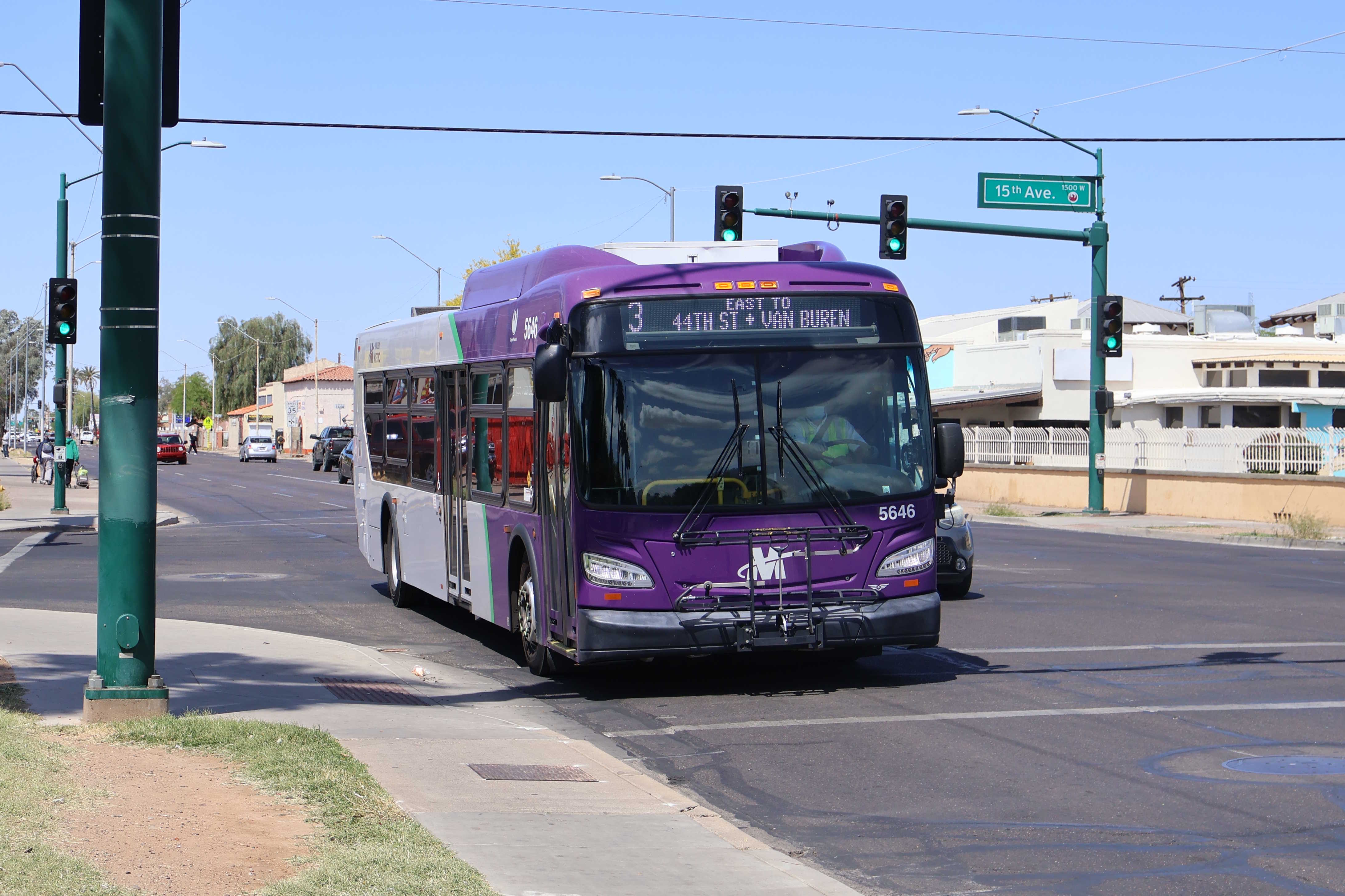 A purple and gray Valley Metro bus, number 5646, traveling eastbound on Van Buren Street in Phoenix on route 3 to Van Buren Street and 44th Street