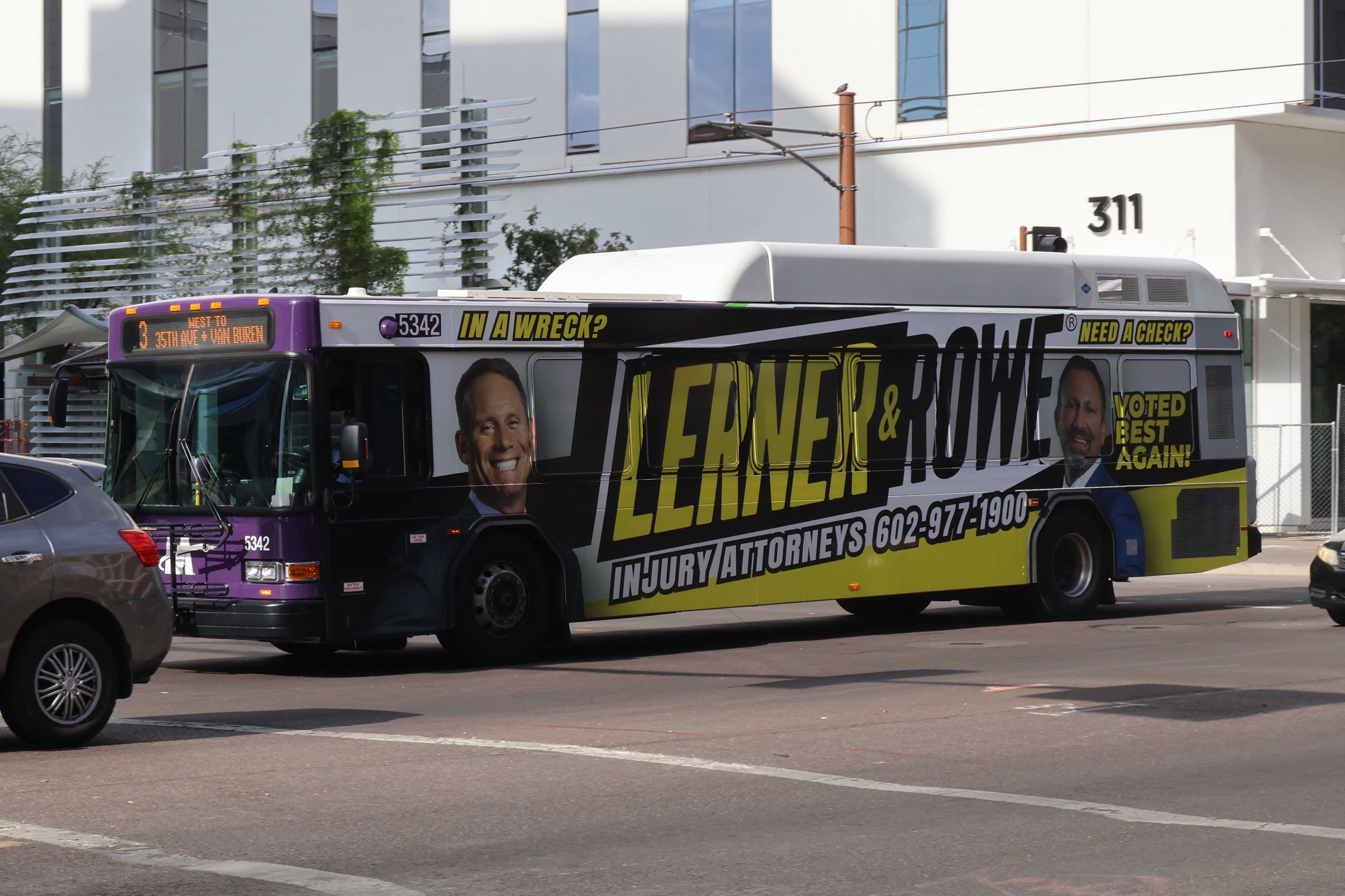 A purple and gray Valley Metro bus, number 5342, traveling westbound on Van Buren Street in Phoenix on route 3 to Van Buren Street and 35th Avenue