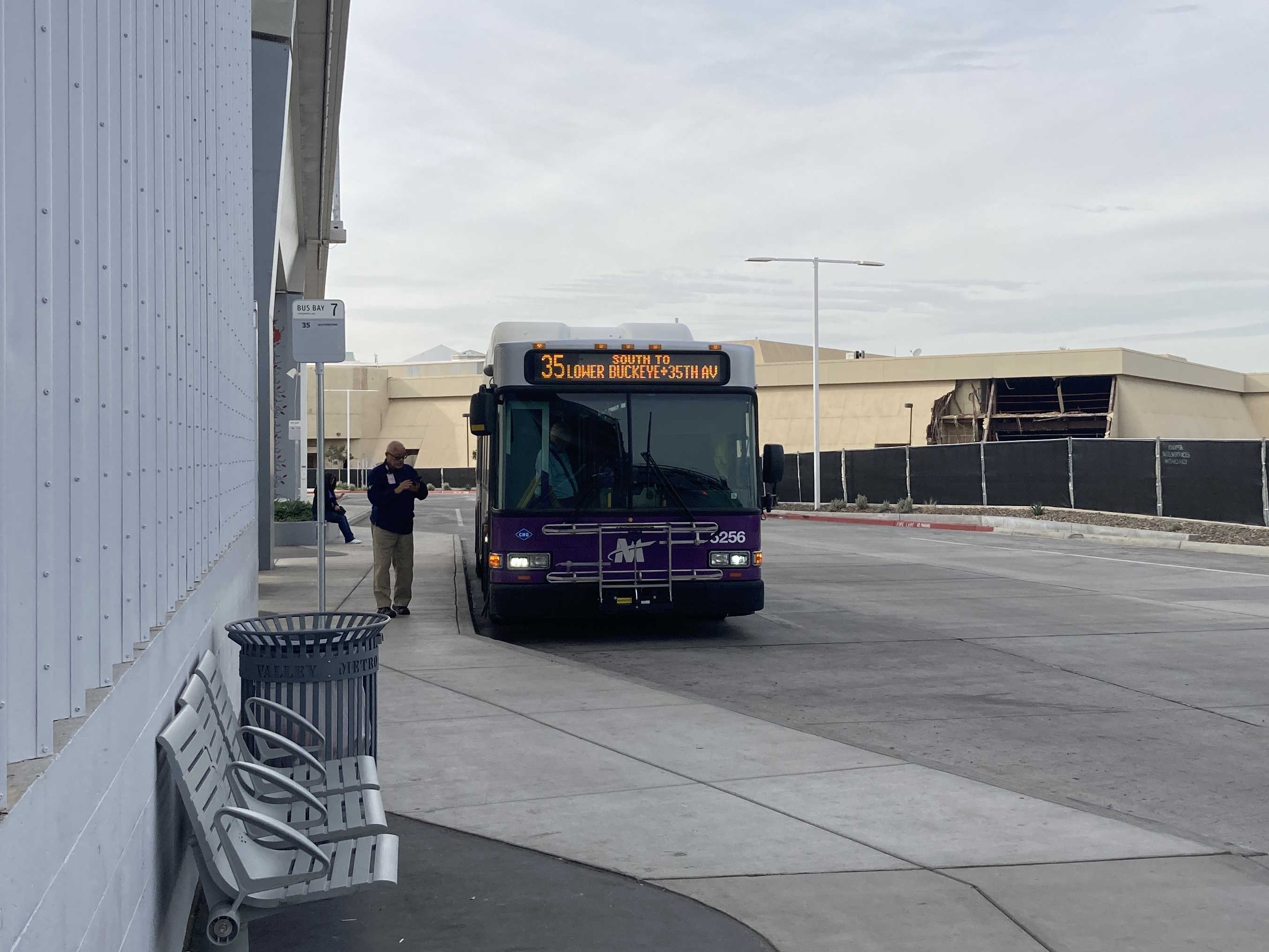 A white and gray Valley Metro bus, with purple and green accent colors, number 5256, at Thelda Williams Transit Center in Phoenix on route 35 to 35th Avenue and Lower Buckeye Road