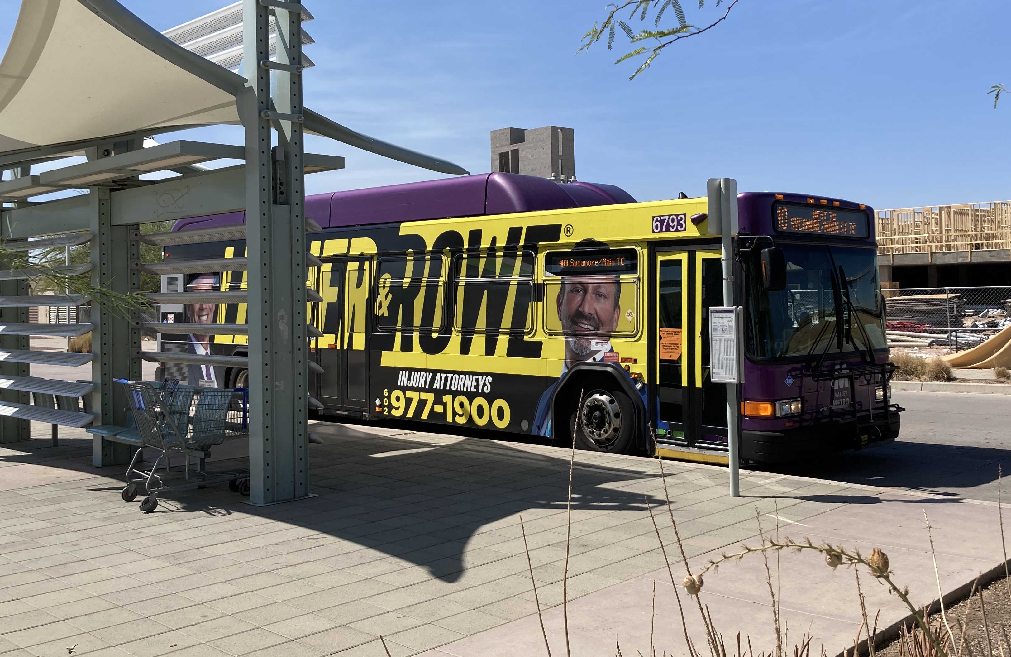 A gray and purple Valley Metro bus, with a white and green stripe, number 6793, at the Sycamore/Main Street Transit Center, the beginning of route 40 to Superstition Springs Transit Center