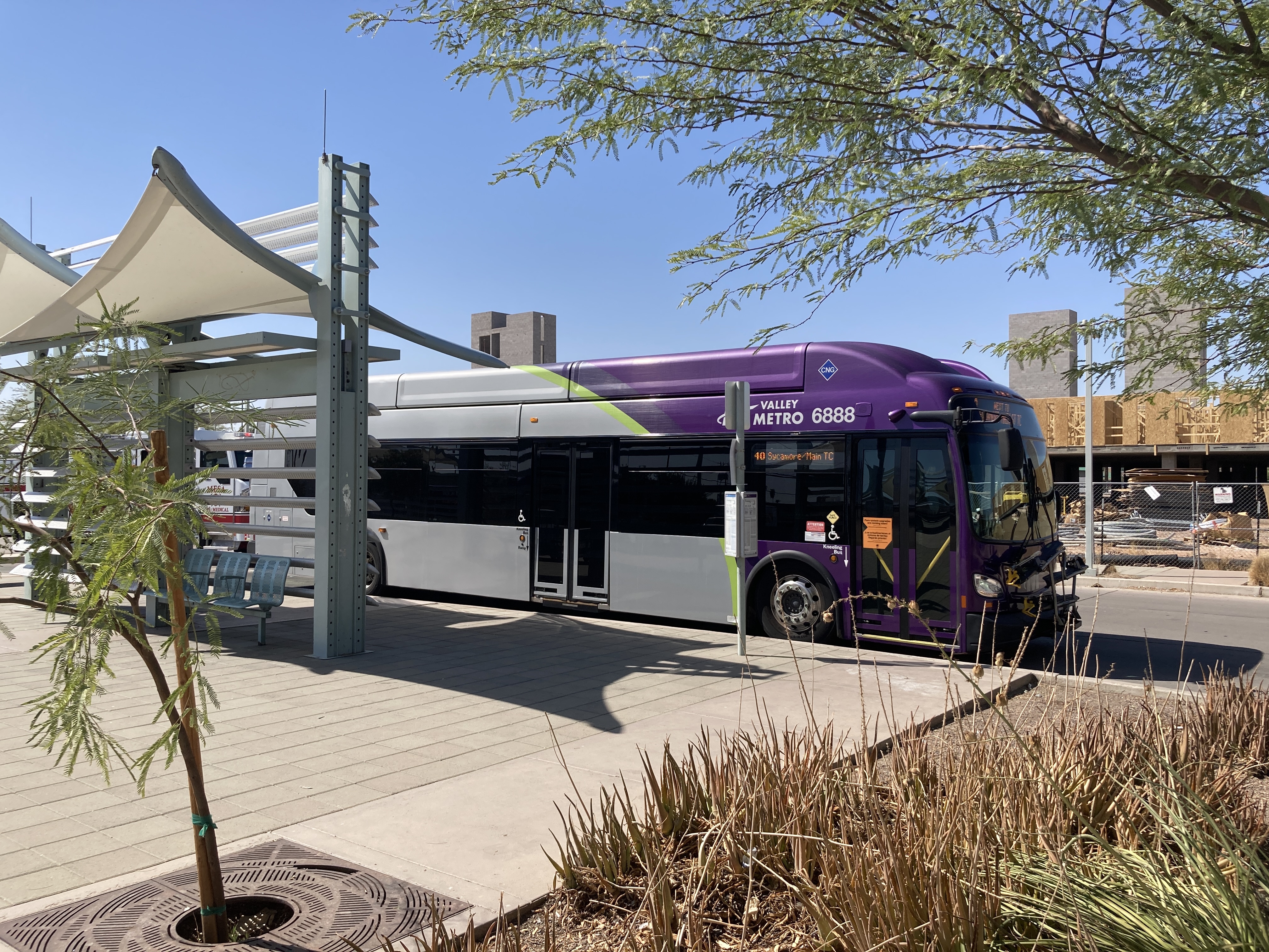 A gray and purple Valley Metro bus, with a green stripe, number 6888, at the Sycamore/Main Street Transit Center, the beginning of route 40 to Superstition Springs Transit Center