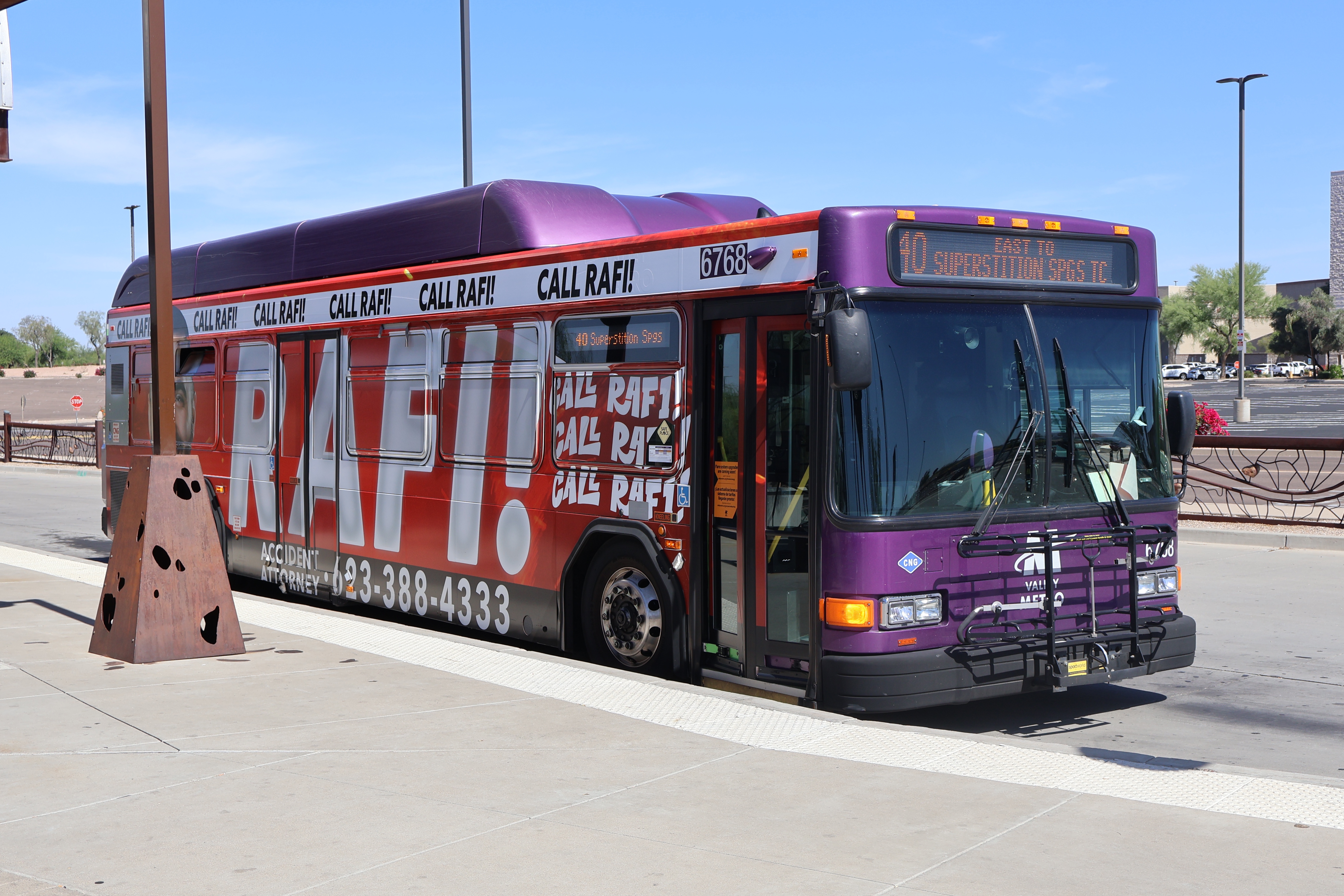 A gray and purple Valley Metro bus, with a white and green stripe, number 6768, at Superstition Springs Transit Center in Mesa on route 40 to Superstition Springs Transit Center