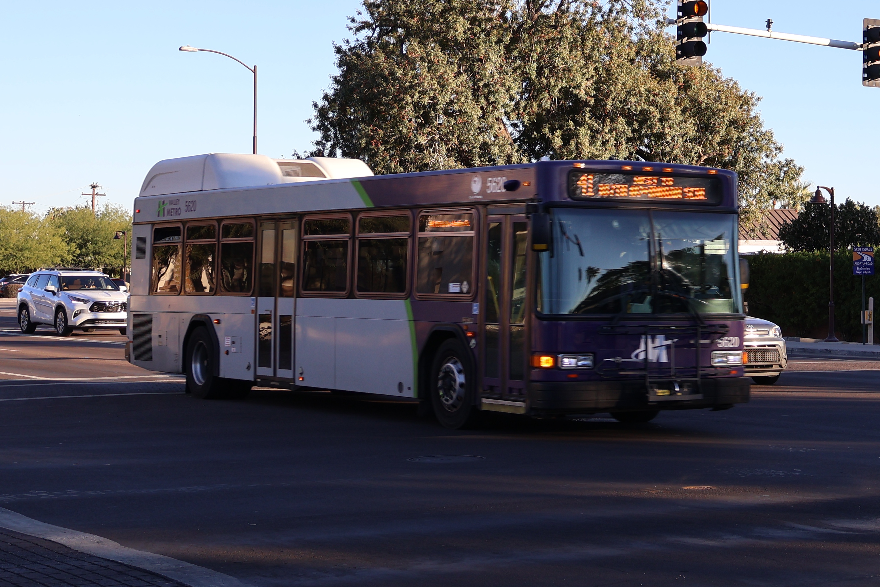 A purple and gray Valley Metro bus, number 5620, traveling westbound on Indian School Road in Scottsdale on route 41 to Indian School Road and 107th Avenue