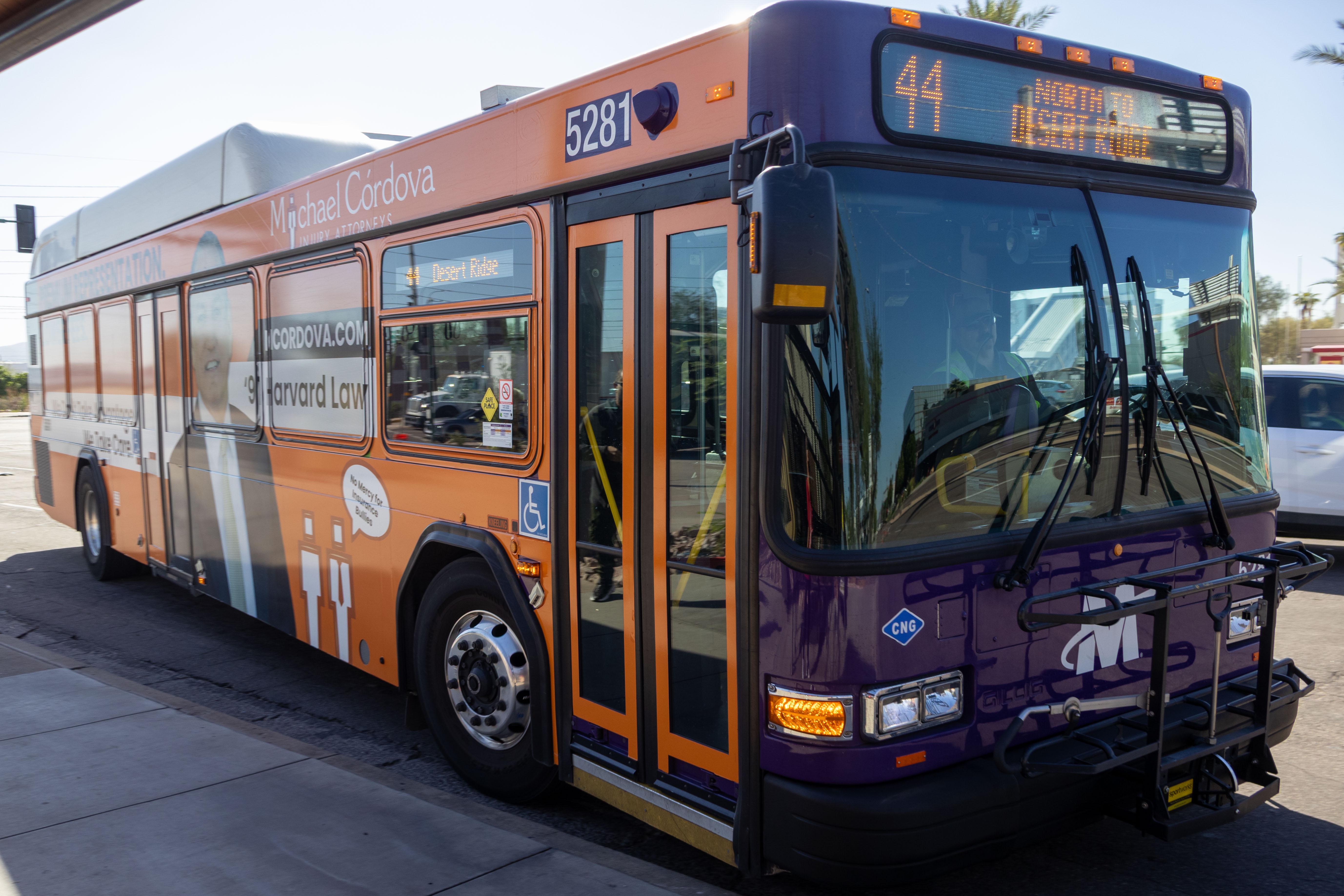 A purple and gray Valley Metro bus, number 5281, traveling northbound on 44th Street in Phoenix on route 44 to Desert Ridge Resort