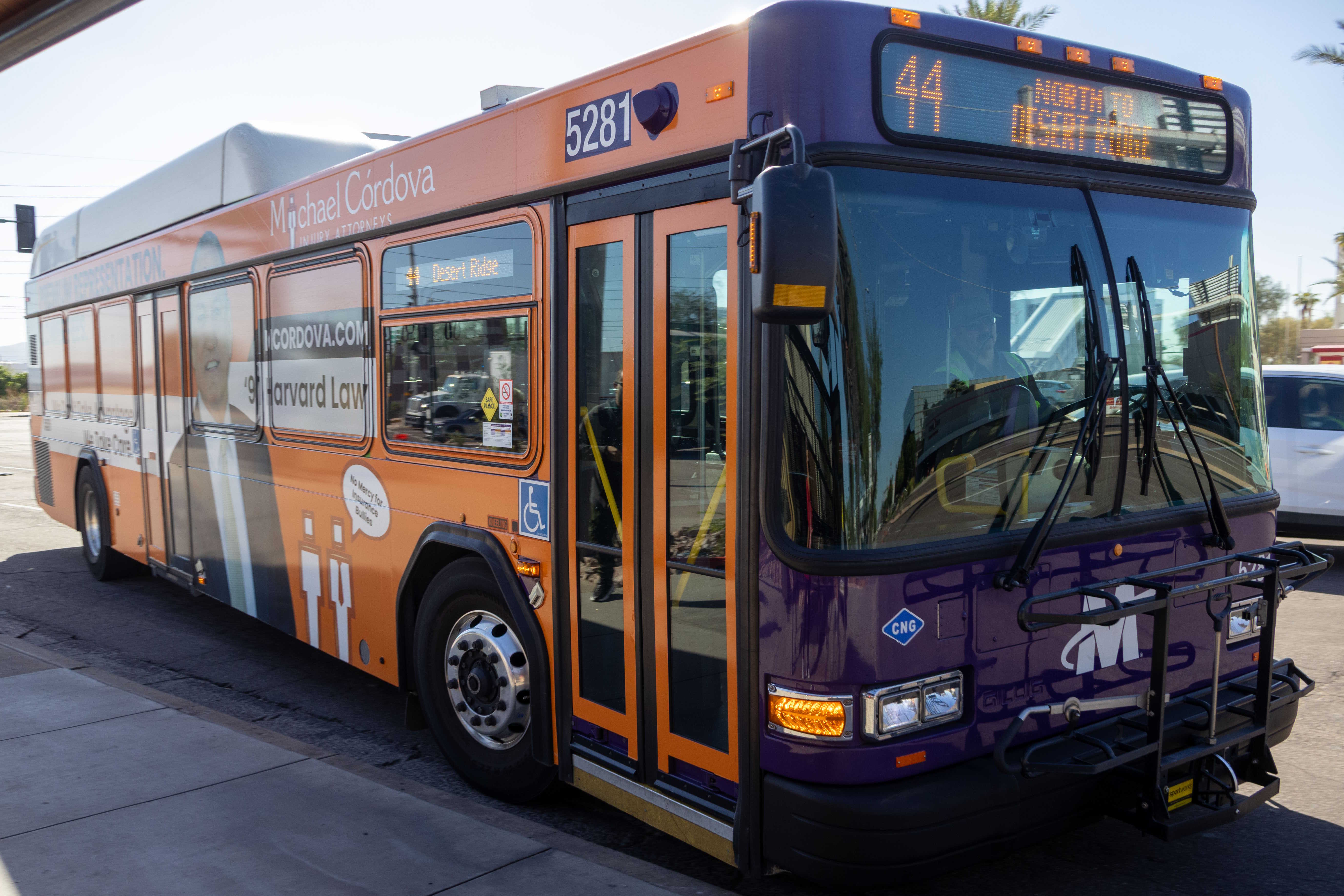 A purple and gray Valley Metro bus, number 5281, traveling northbound on 44th Street in Phoenix on route 44 to Desert Ridge Resort