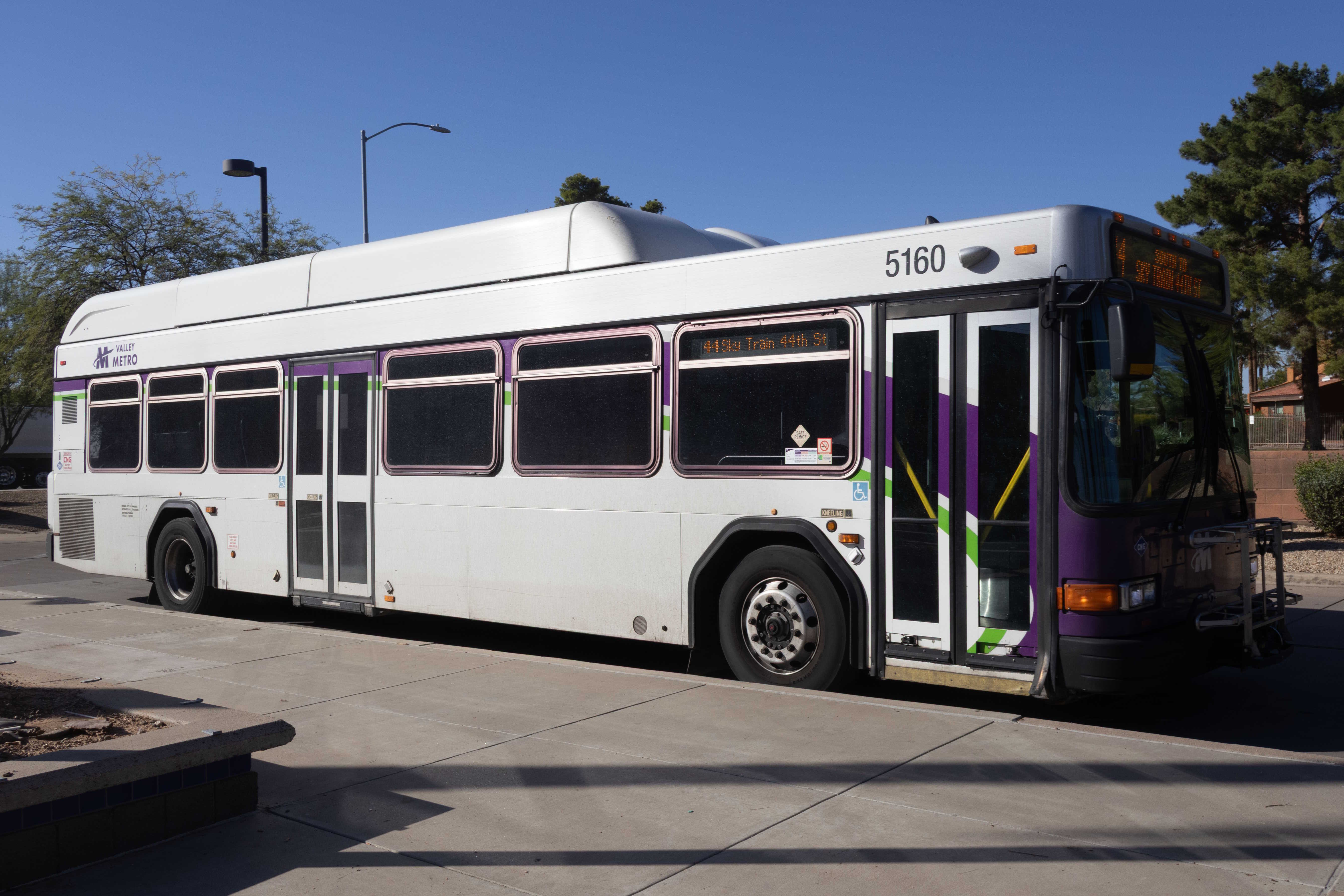 A white and gray Valley Metro bus, with purple and green accent colors, number 5160, at Paradise Valley Transit Center in Phoenix on route 44 to 44th Street Sky Train Station