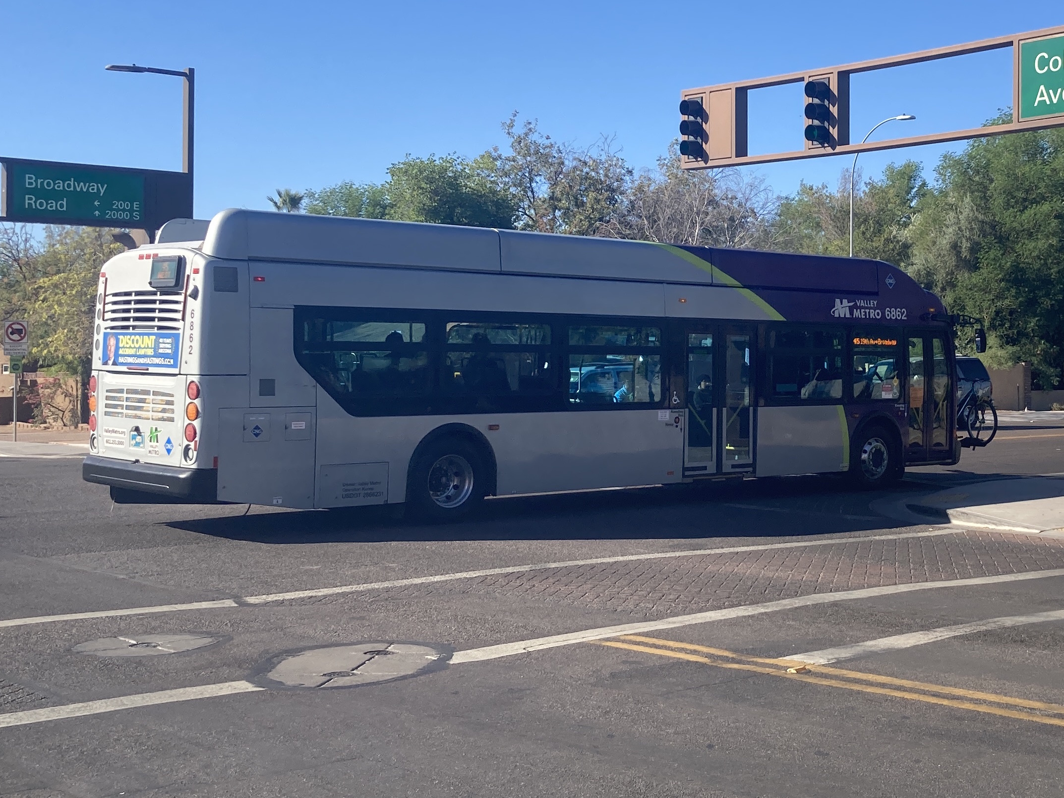 A gray and purple Valley Metro bus, number 6862, traveling westbound on Broadway Road in Tempe on route 45 to Broadway Road and 19th Avenue