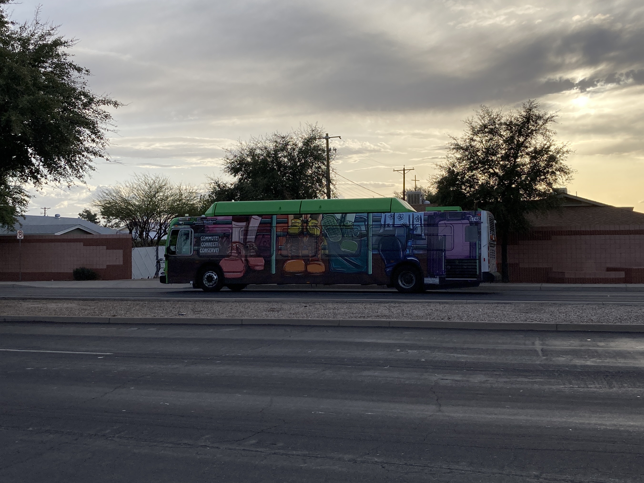 A gray and green Valley Metro bus, number 6748, traveling southbound on Gilbert Road in Mesa on route 45 to Broadway Road and 19th Avenue