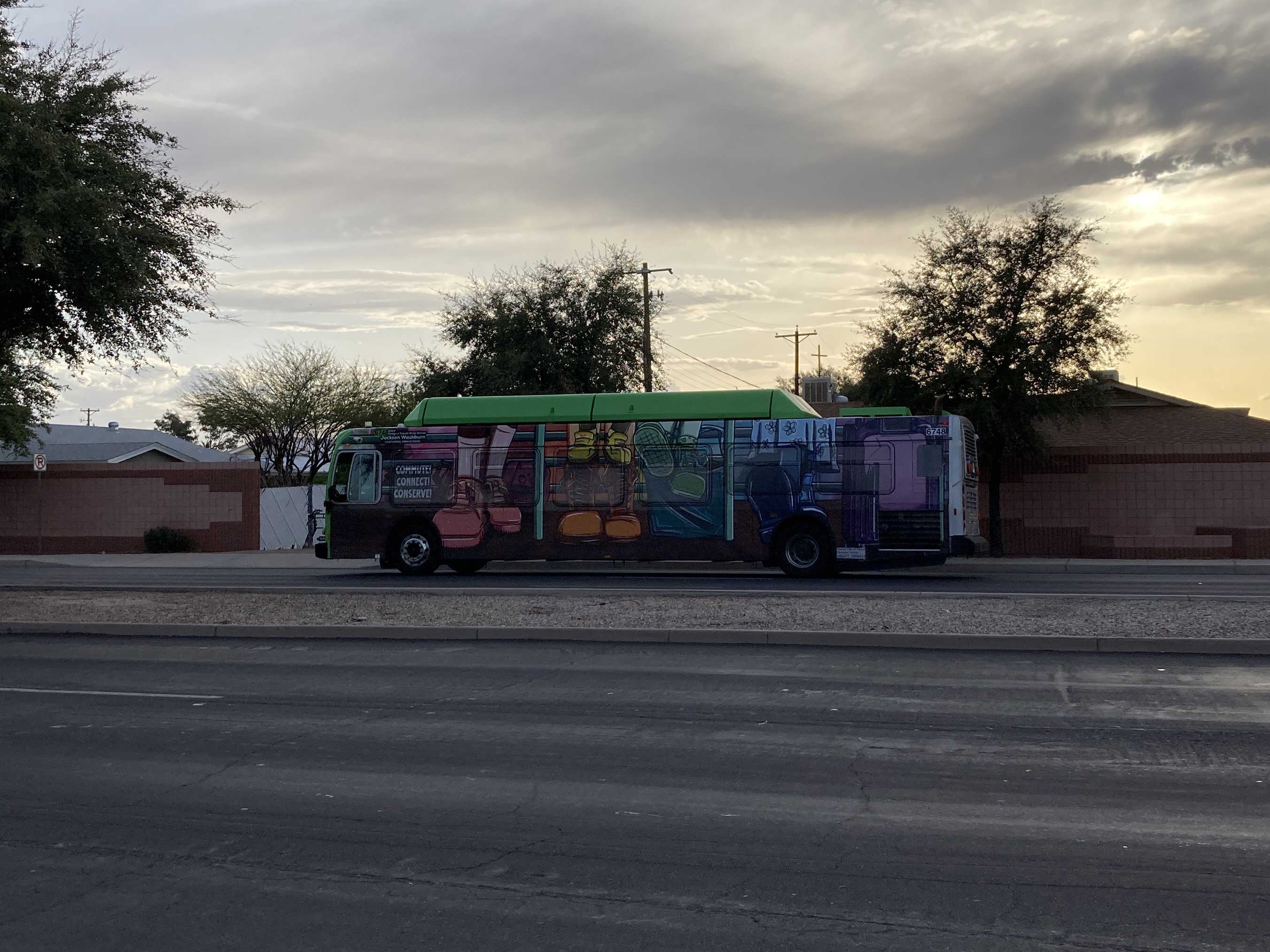 A gray and green Valley Metro bus, number 6748, traveling southbound on Gilbert Road in Mesa on route 45 to Broadway Road and 19th Avenue