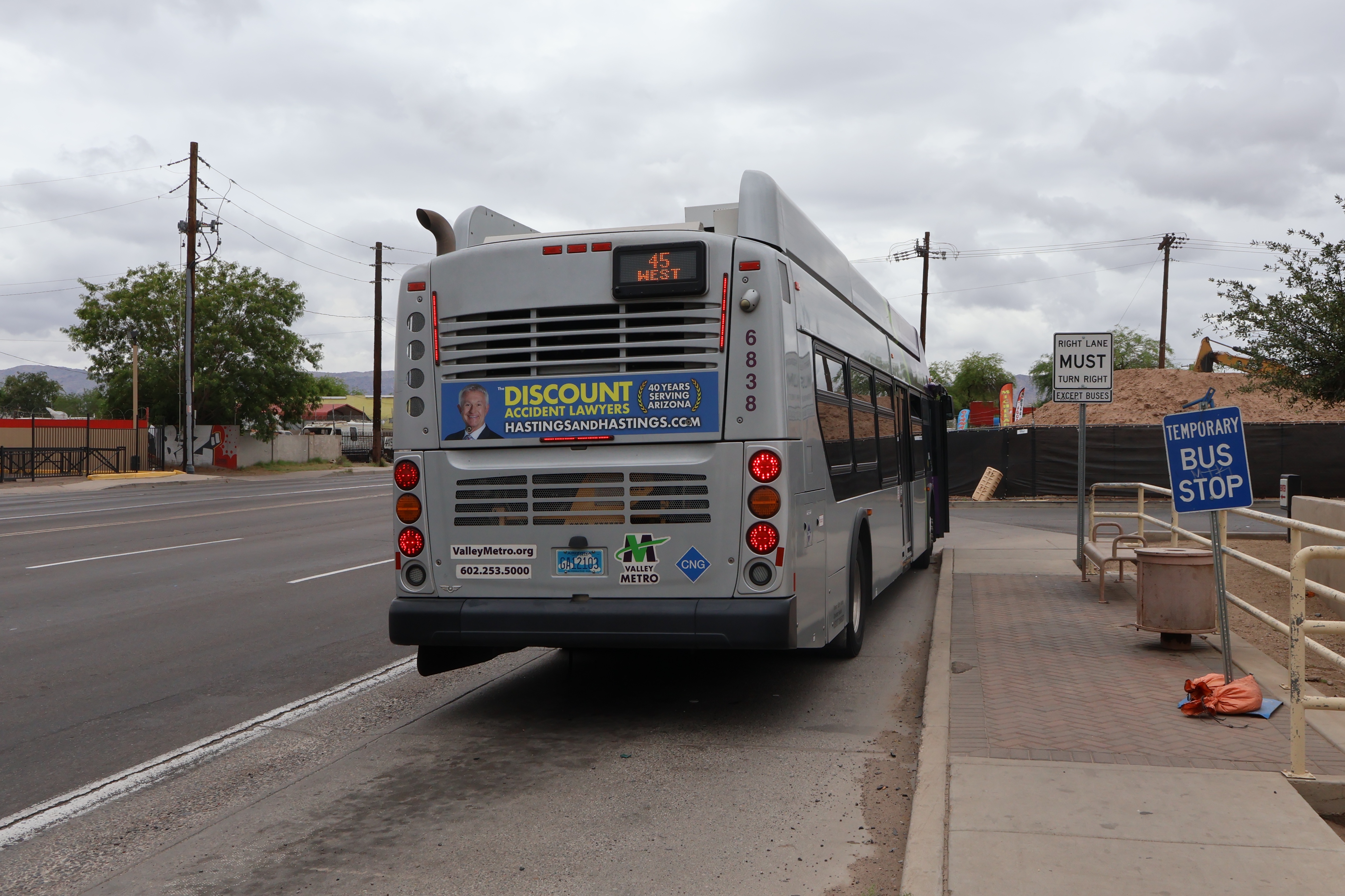 A gray and purple Valley Metro bus, number 6838, traveling southbound on 19th Avenue in Phoenix on route 45 to Broadway Road and 19th Avenue