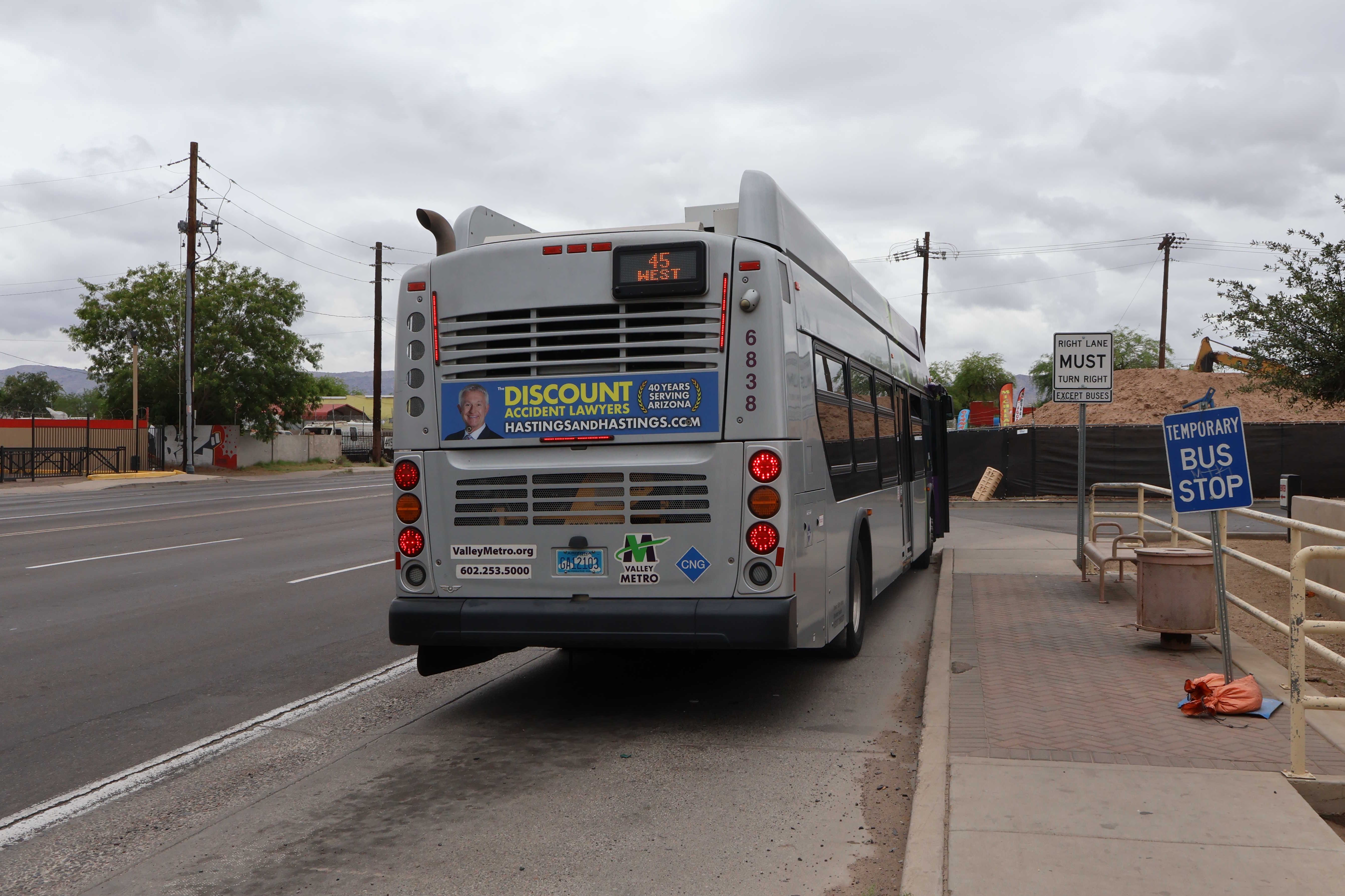A gray and purple Valley Metro bus, number 6838, traveling southbound on 19th Avenue in Phoenix on route 45 to Broadway Road and 19th Avenue
