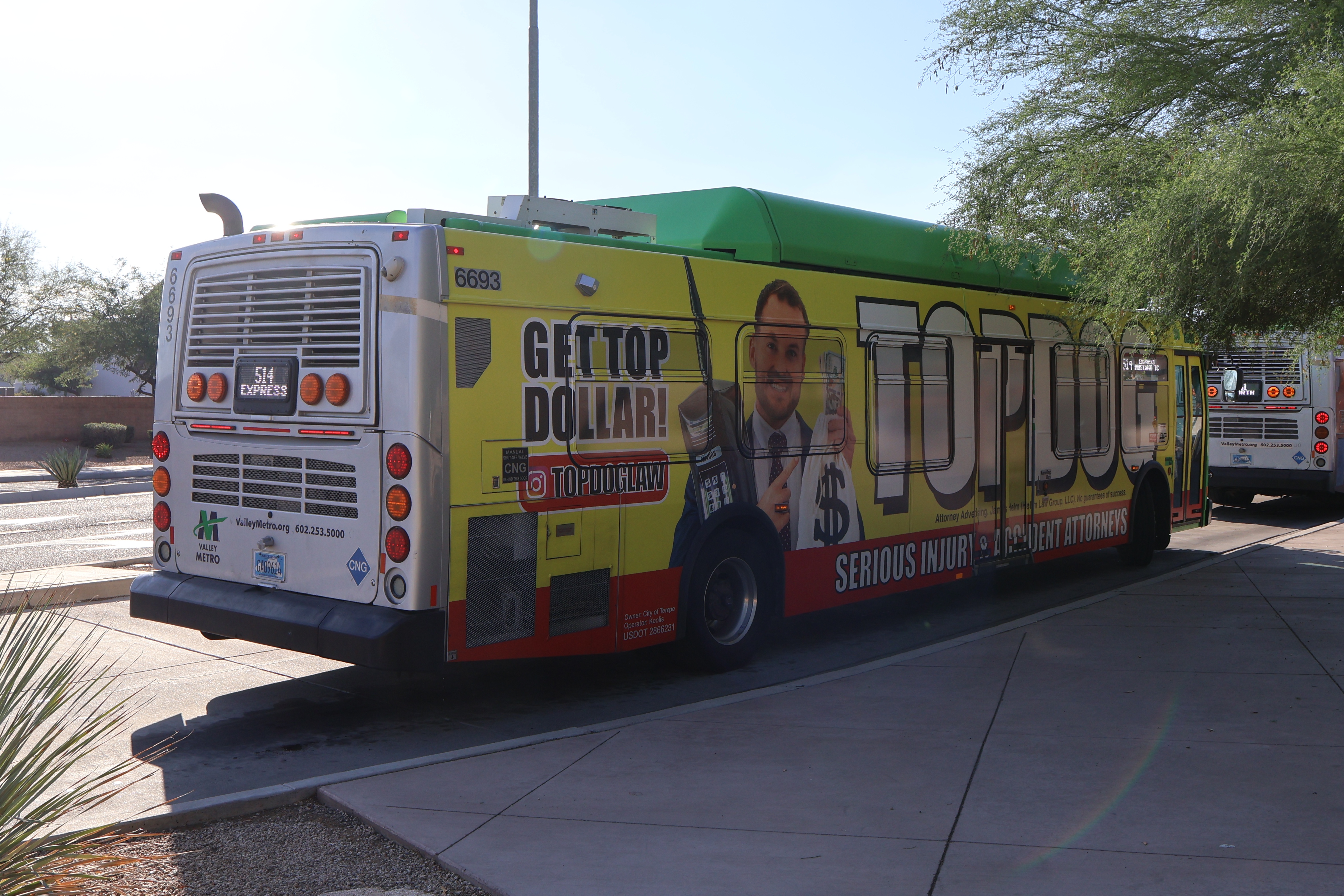 A green and gray Valley Metro bus, with a purple stripe, number 6693, at Mustang Transit Center in Scottsdale on route 514 to Mustang Transit Center