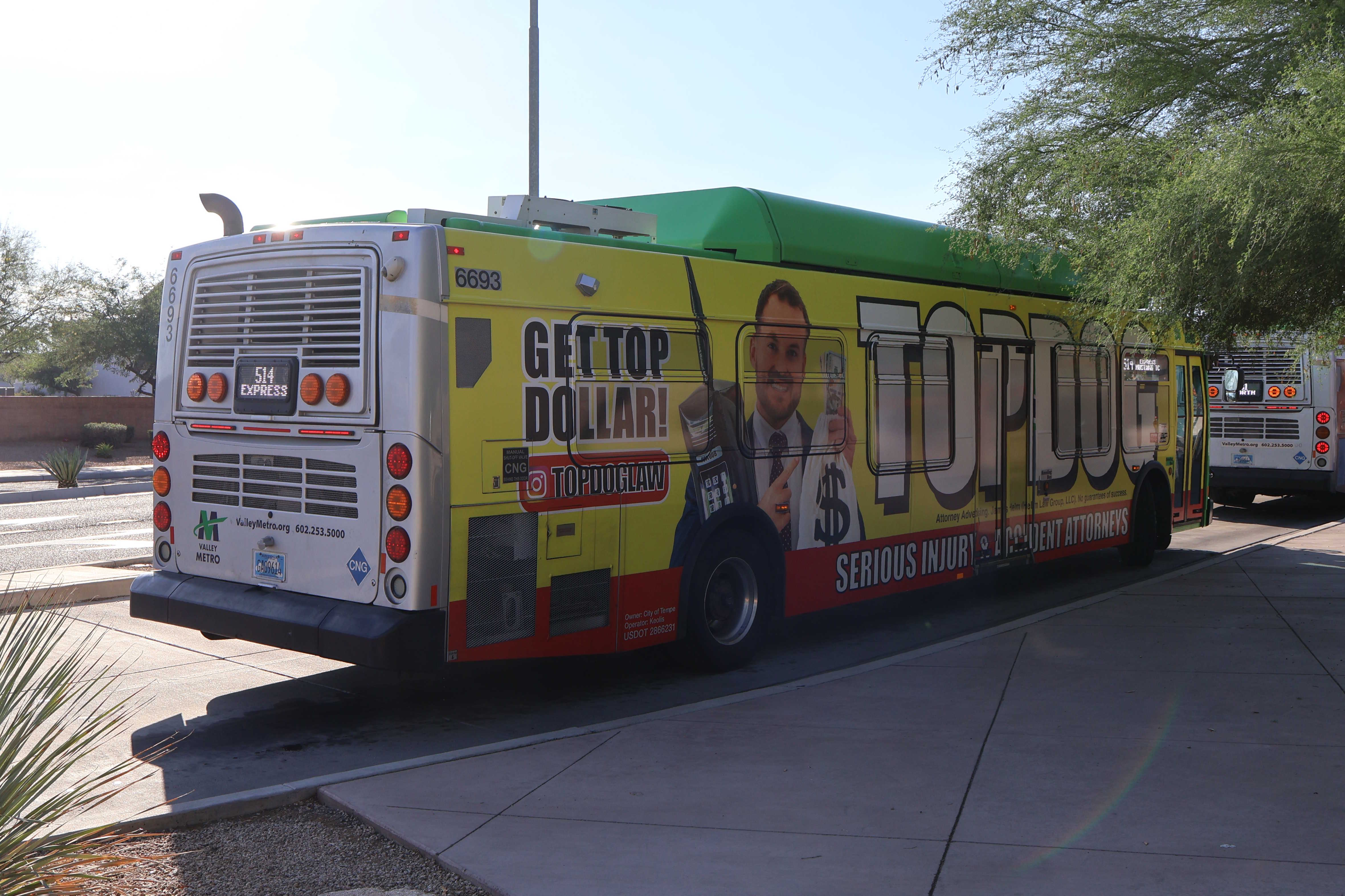 A green and gray Valley Metro bus, with a purple stripe, number 6693, at Mustang Transit Center in Scottsdale on route 514 to Mustang Transit Center