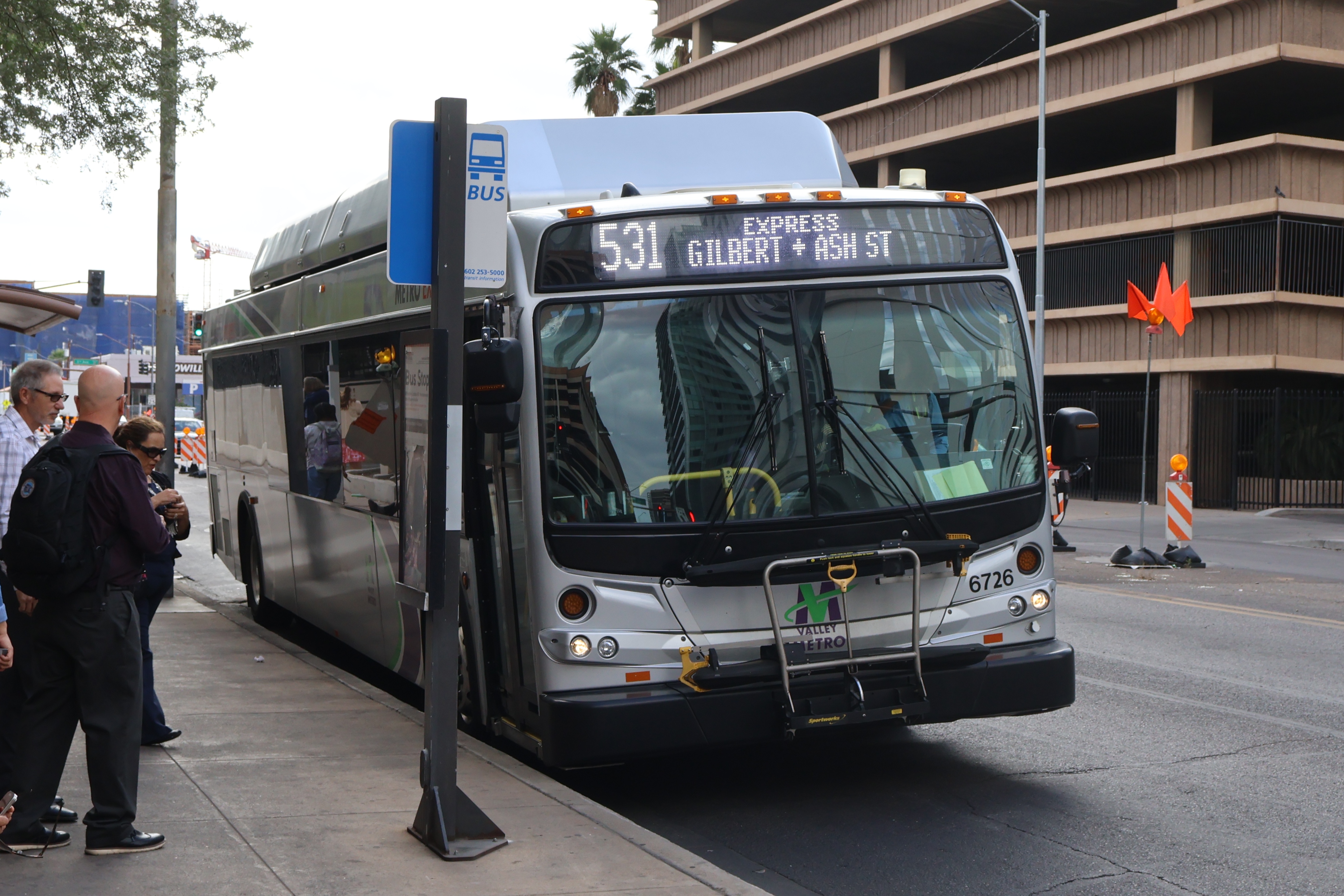 A silver Valley Metro bus, with green, purple, and white stripes, number 6726, traveling eastbound on Van Buren Street in Phoenix on route 531 to Gilbert Road and Ash Street