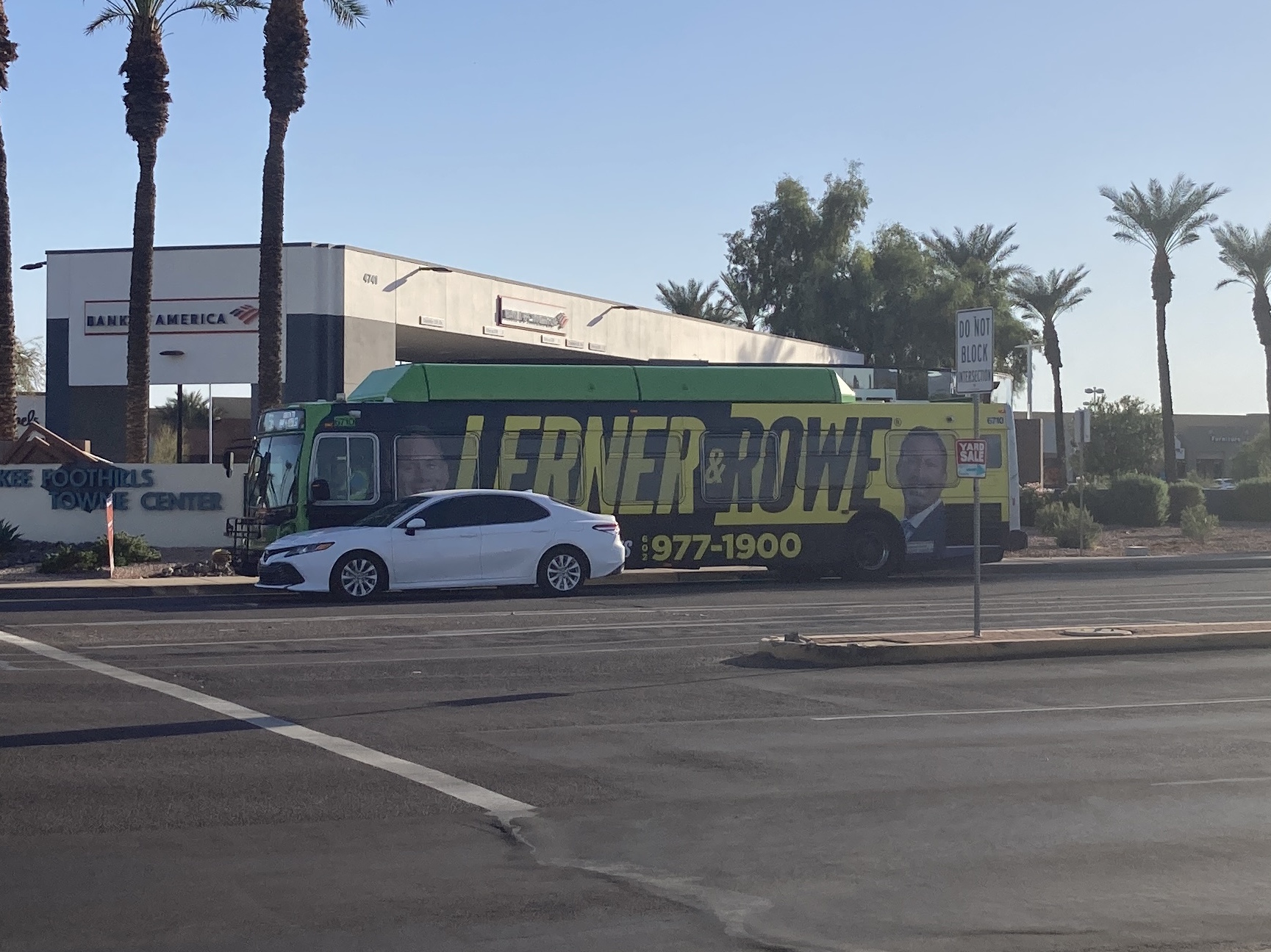 A green Valley Metro bus, number 6710, traveling eastbound on Ray Road in Phoenix on route 56 to Ray Road & 48th Street