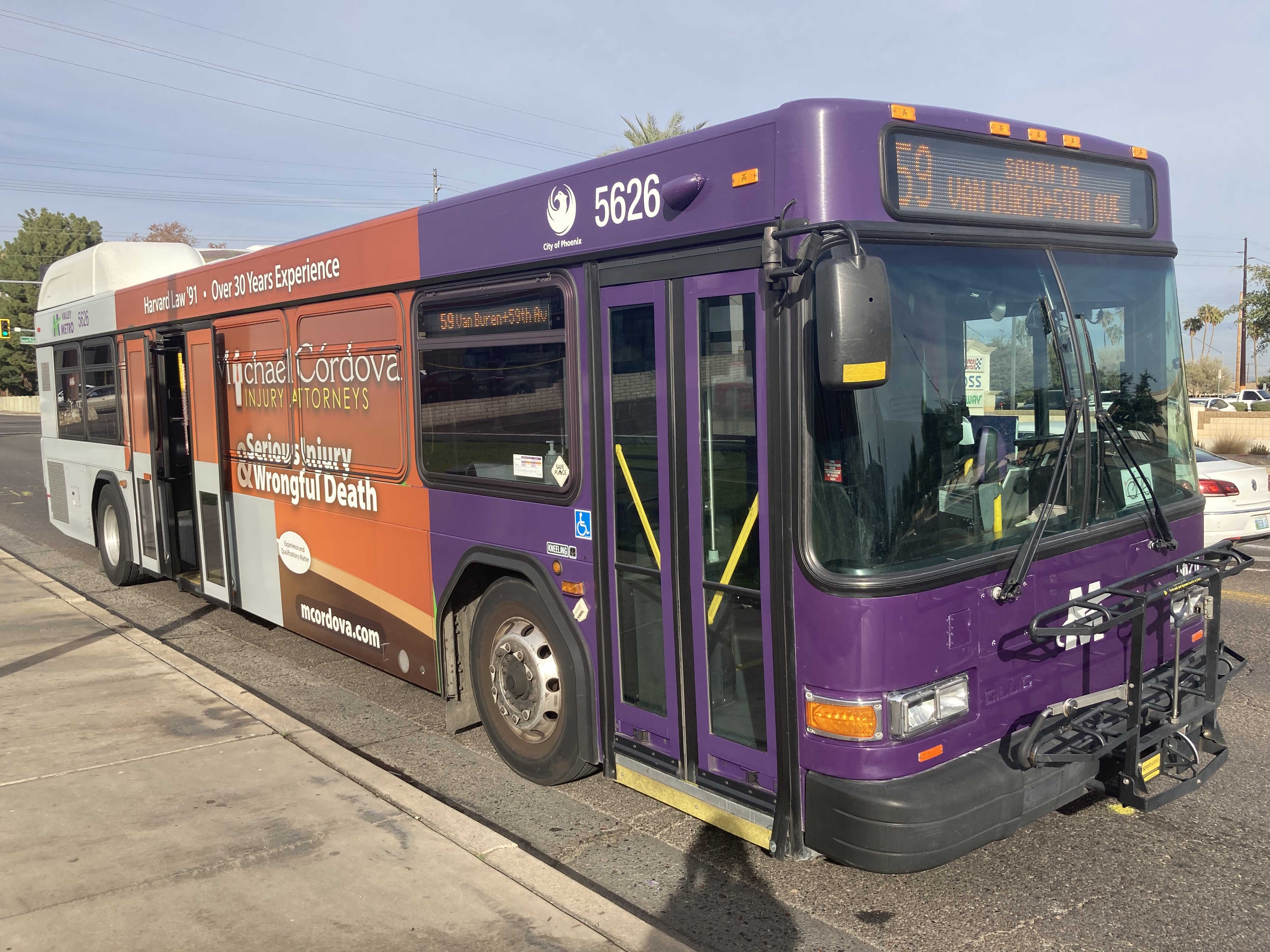 A purple and gray Valley Metro bus, number 5626, traveling southbound on 59th Avenue in Glendale on route 59s to 59th Avenue and Van Buren Street