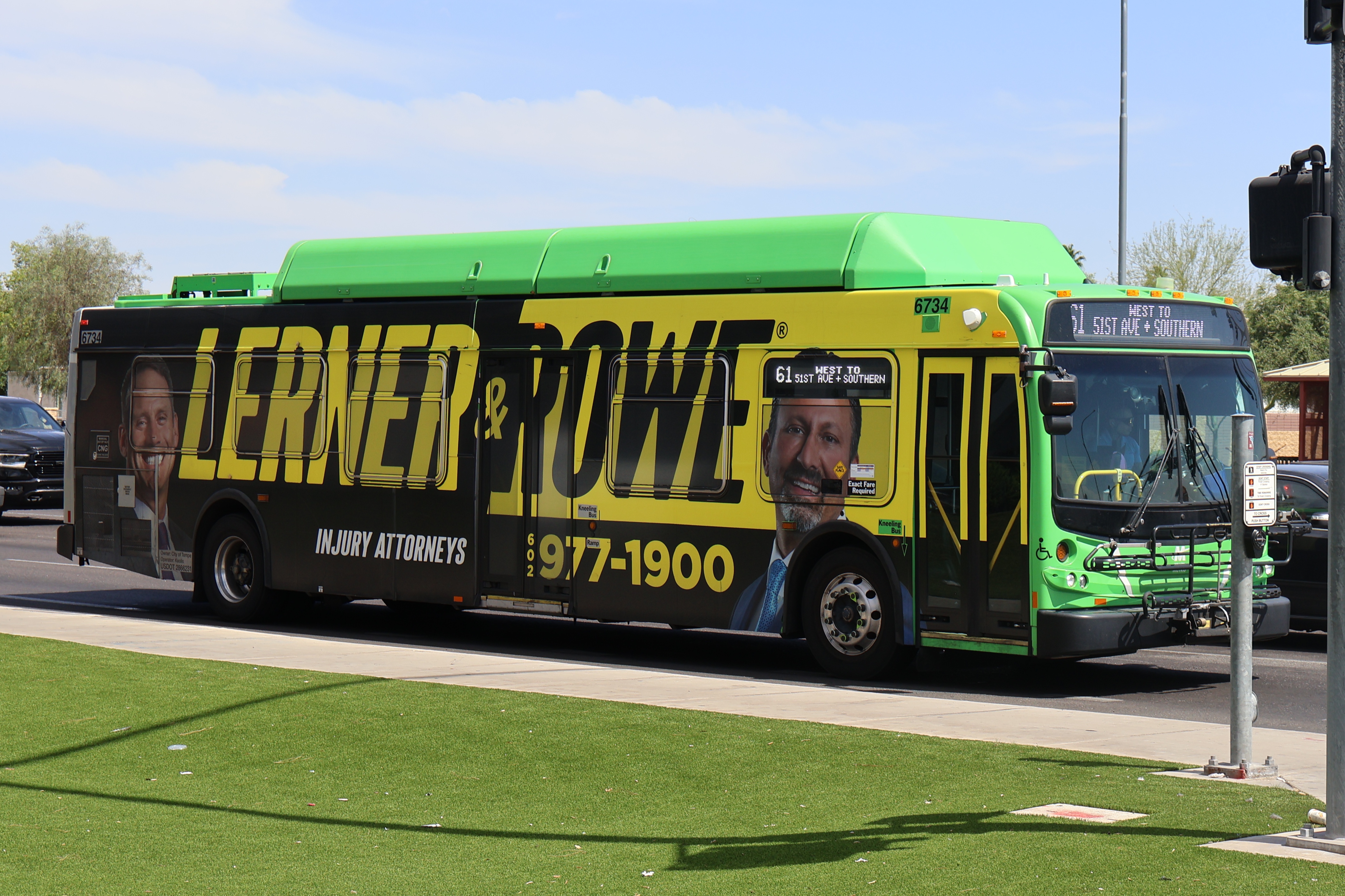 A gray and green Valley Metro bus, number 6734, traveling westbound on Southern Avenue in Mesa on route 61 to Southern Avenue and 51st Avenue