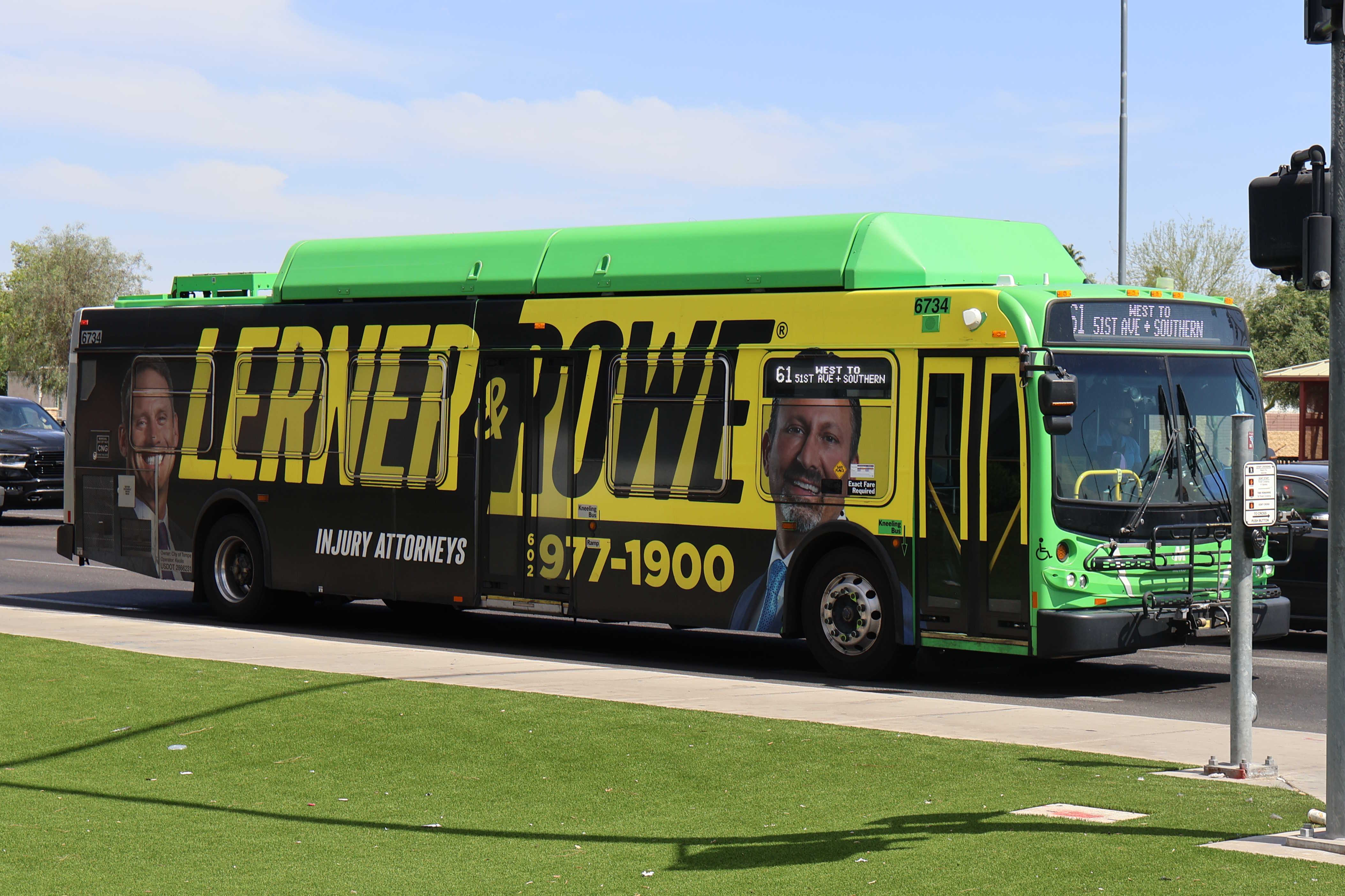 A gray and green Valley Metro bus, number 6734, traveling westbound on Southern Avenue in Mesa on route 61 to Southern Avenue and 51st Avenue