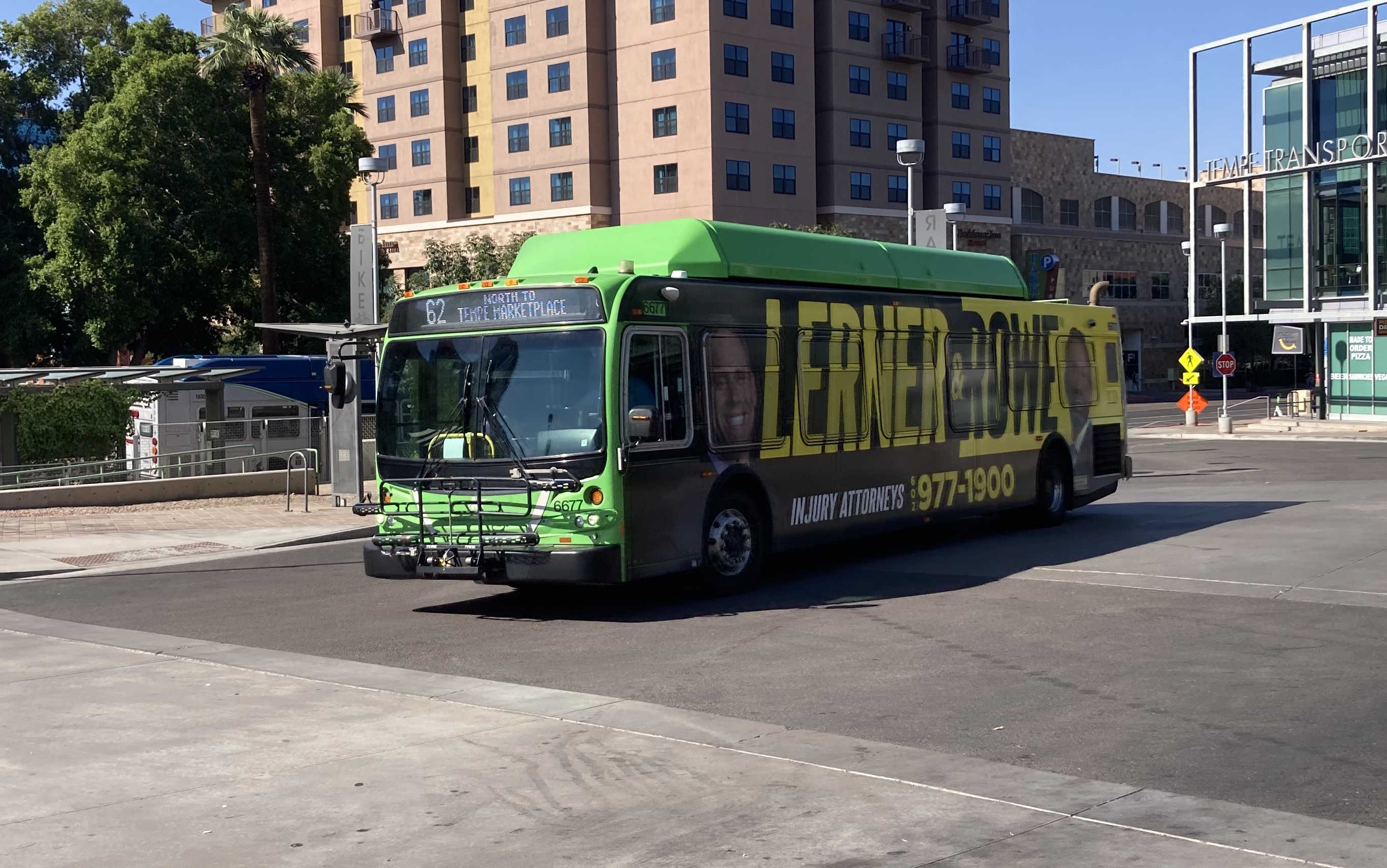 A green Valley Metro bus, number 6677, at the Tempe Transportation Center, traveling route 62 to Tempe Marketplace