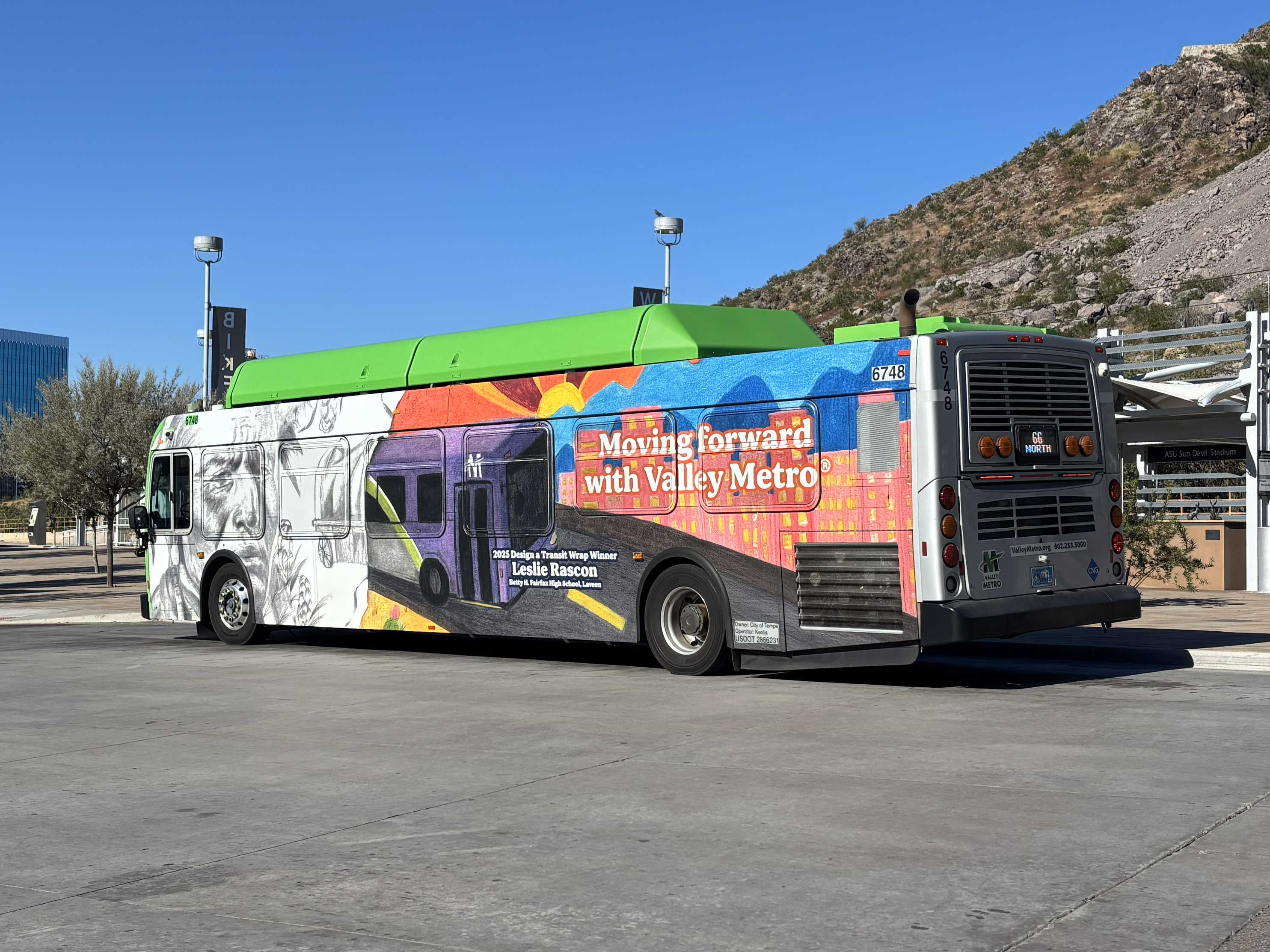A green Valley Metro bus with a purple and white stripe, number 6748, at the Tempe Transportation Center on route 66 to Downtown Tempe / ASU