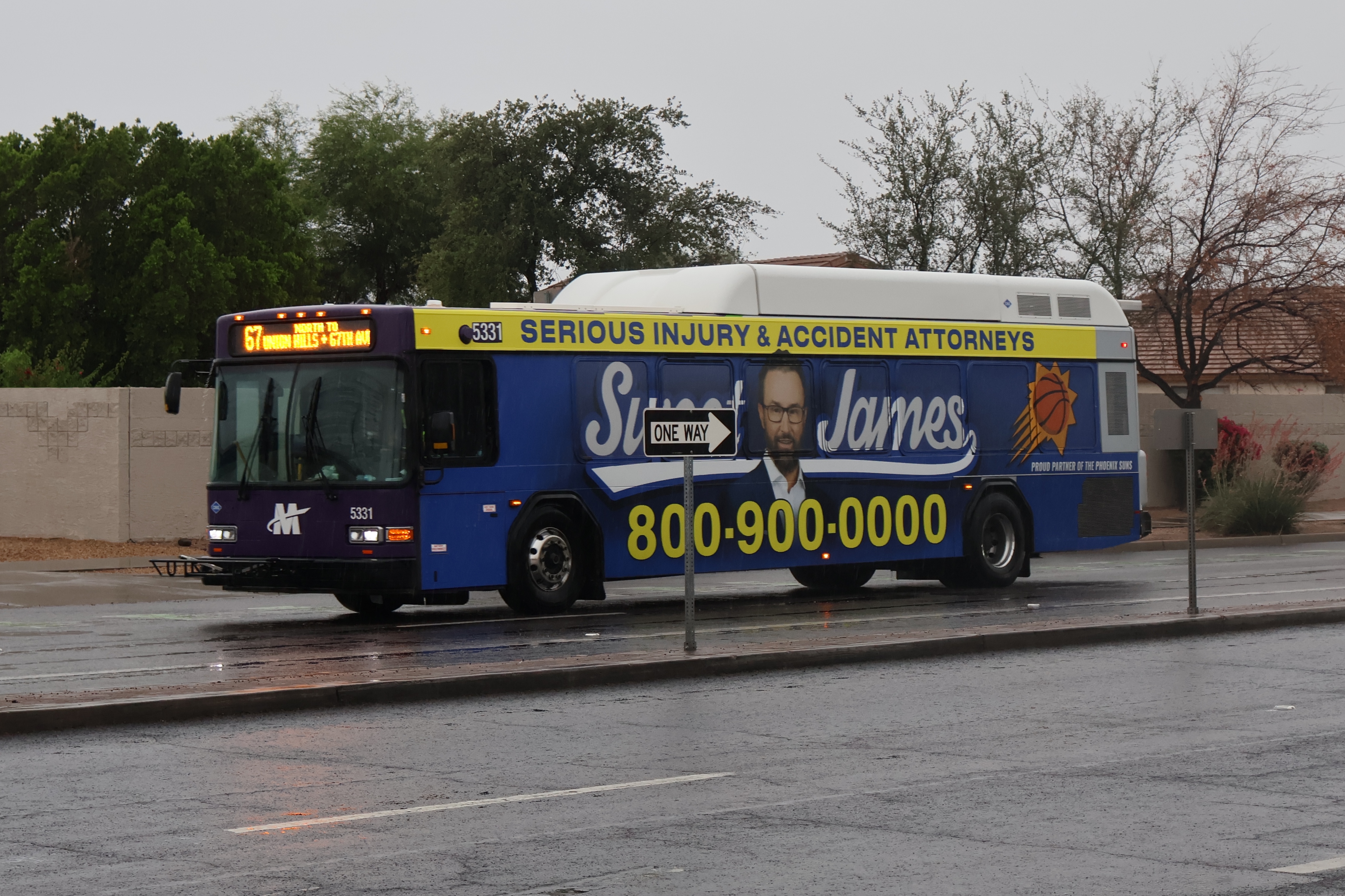 A purple and gray Valley Metro bus, number 5331, traveling northbound on 67th Avenue in Glendale on route 67 to 67th Avenue and Union Hills Drive
