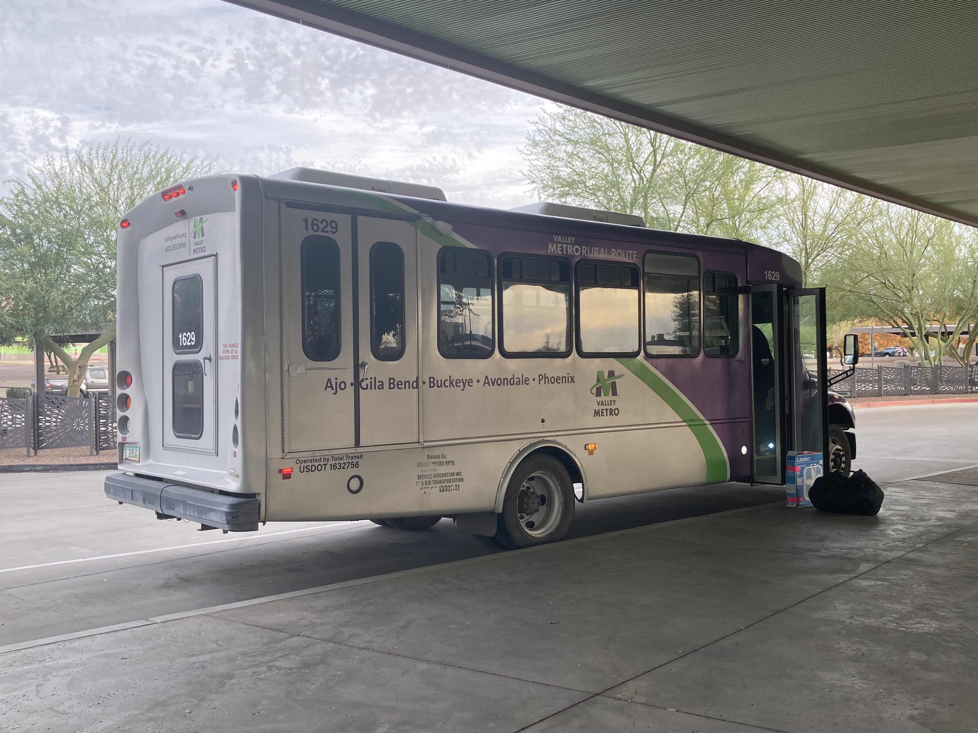 A gray and purple Valley Metro minibus, with a green stripe, number 1629, at Desert Sky Transit Center in Phoenix on route 685 to Ajo