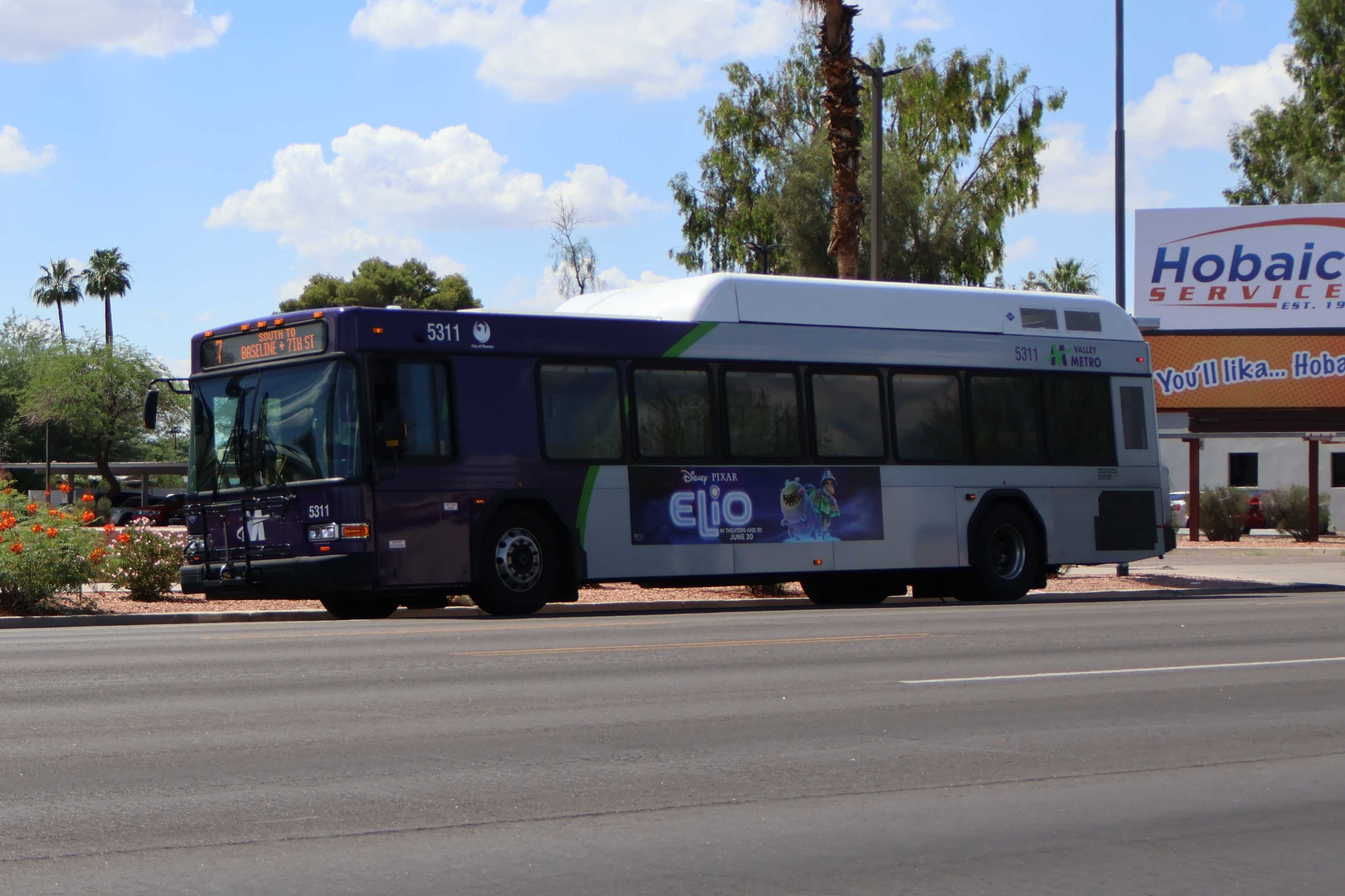 A purple and gray Valley Metro bus, number 5311, traveling southbound on 7th Street in Phoenix on route 7 to 7th Street and Baseline Road