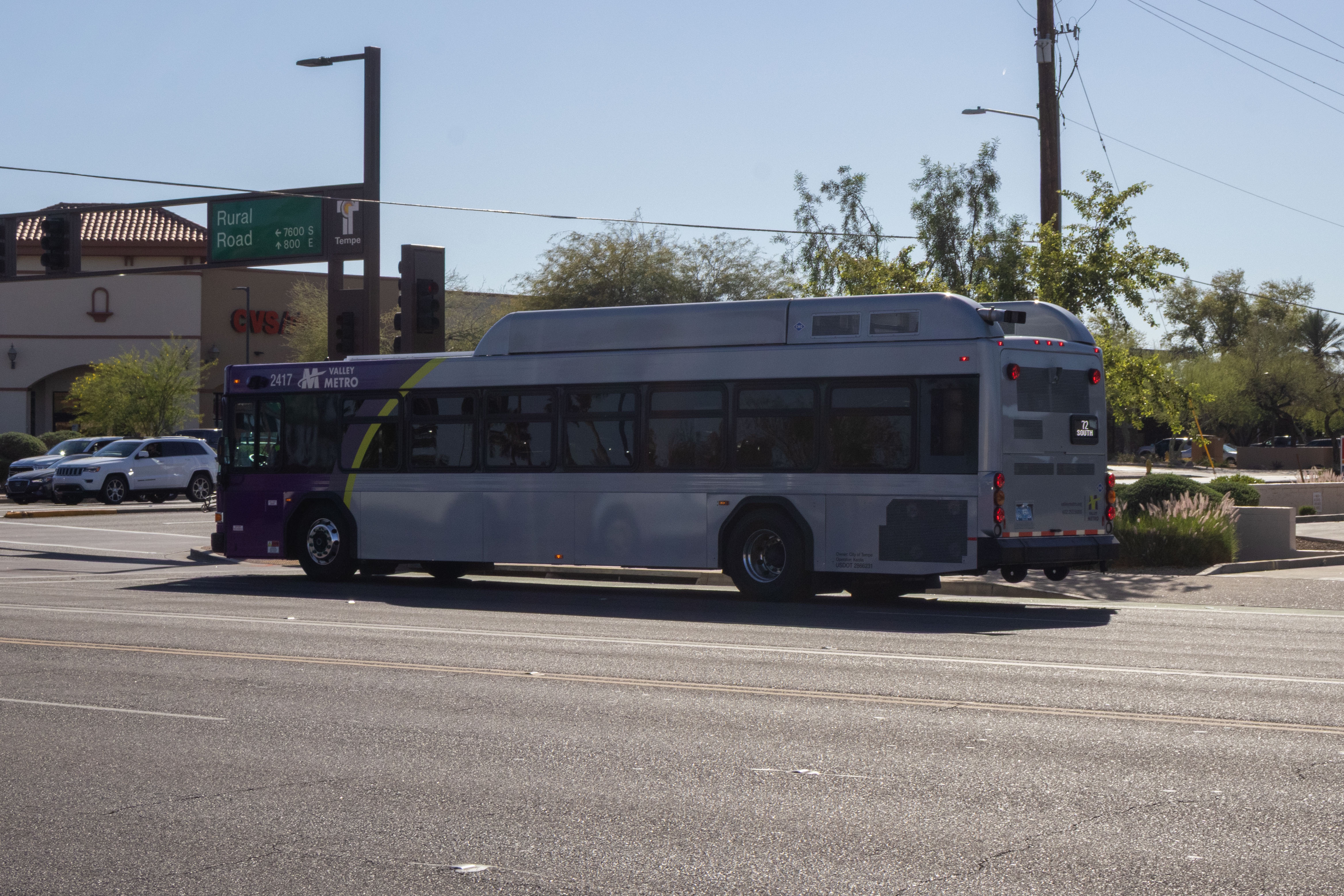 A gray and purple Valley Metro bus, with a green stripe, number 2417, traveling southbound on Rural Road in Tempe on route 72 to Chandler Fashion Center