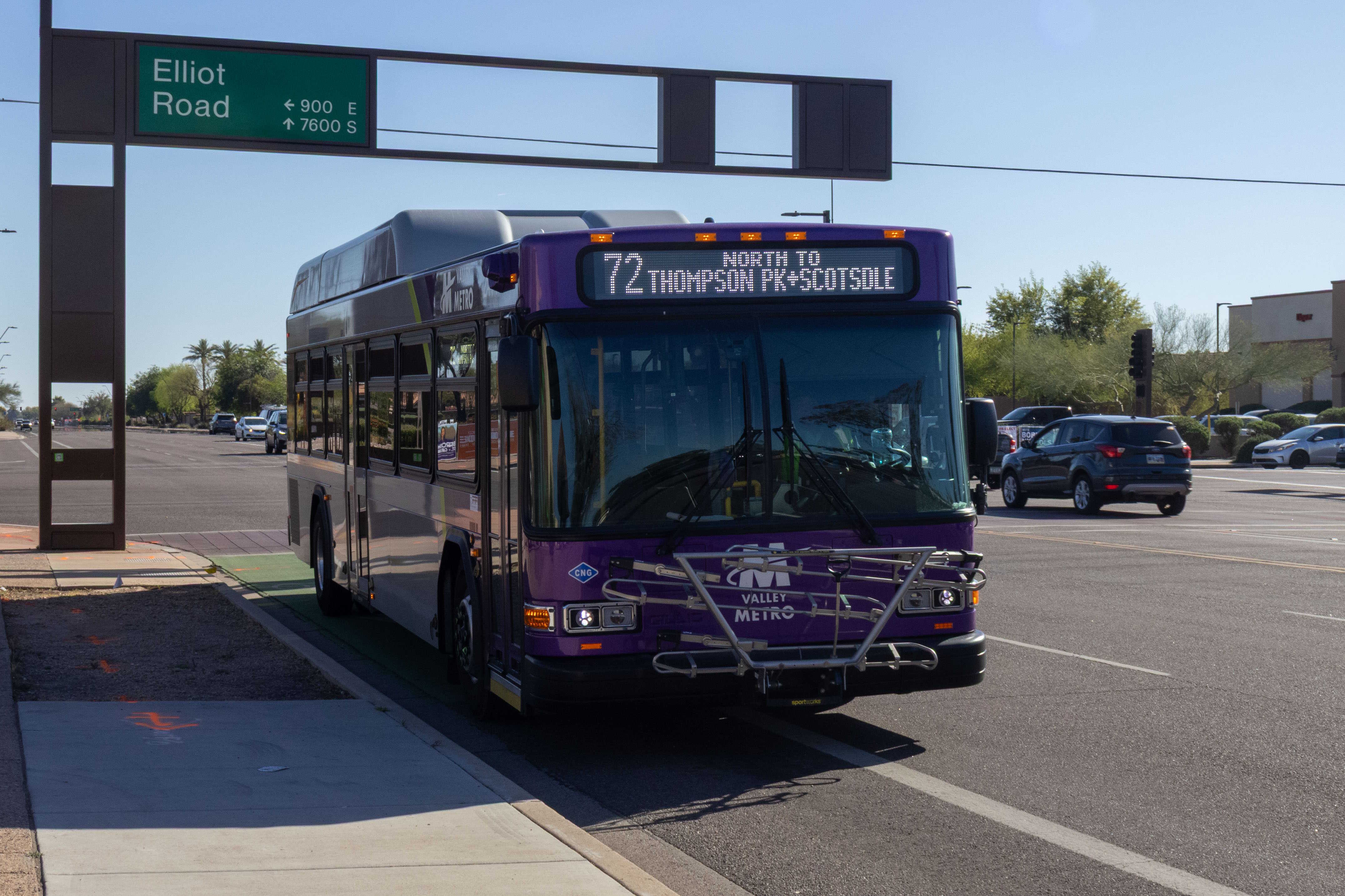 A gray and purple Valley Metro bus, with a green stripe, number 2414, traveling northbound on Rural Road in Tempe on route 72 to Thompson Peak Parkway and Scottsdale Healthcare