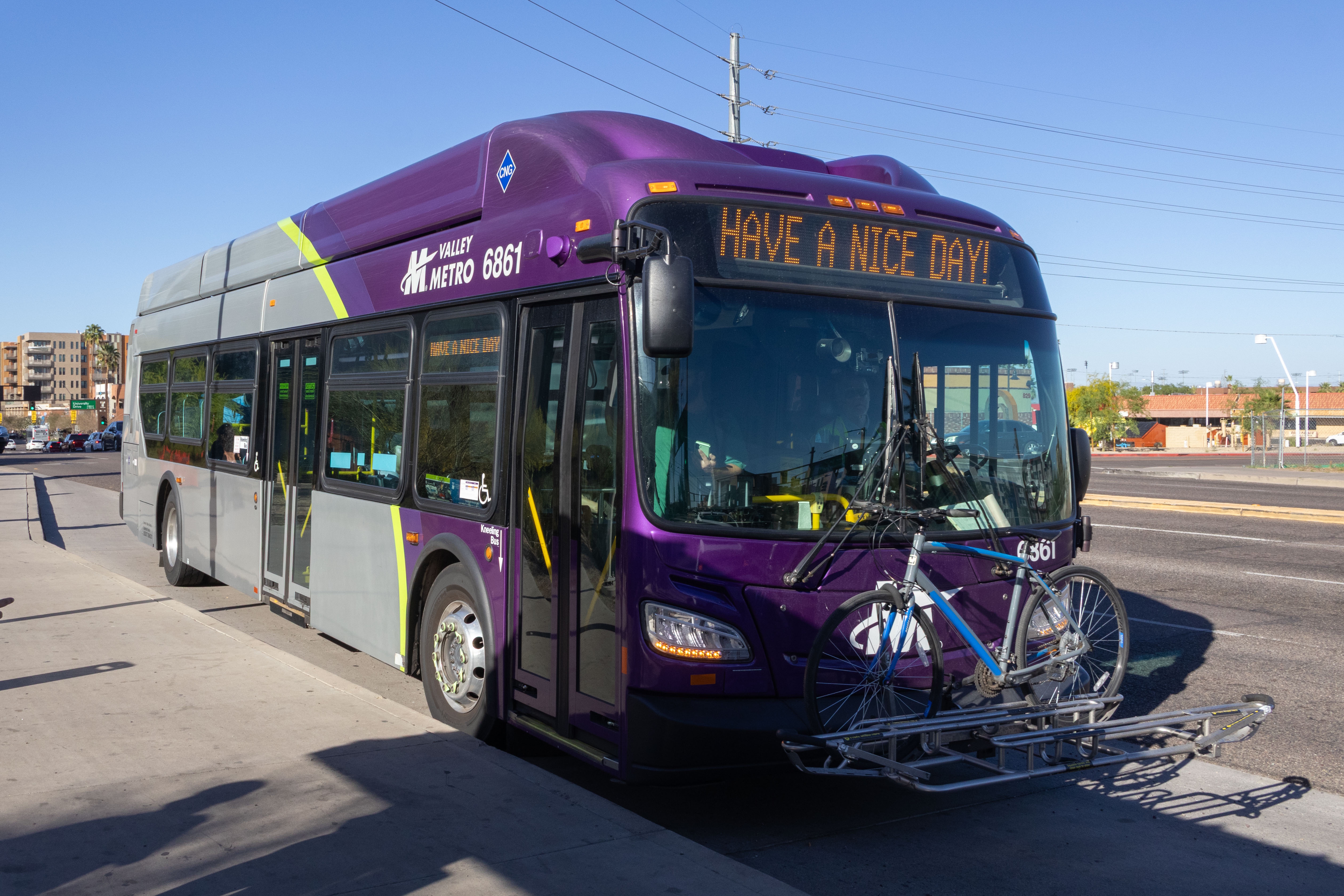 A gray and purple Valley Metro bus, with a green stripe, number 6861, traveling southbound on Rural Road in Tempe on route 72 to Chandler Fashion Center
