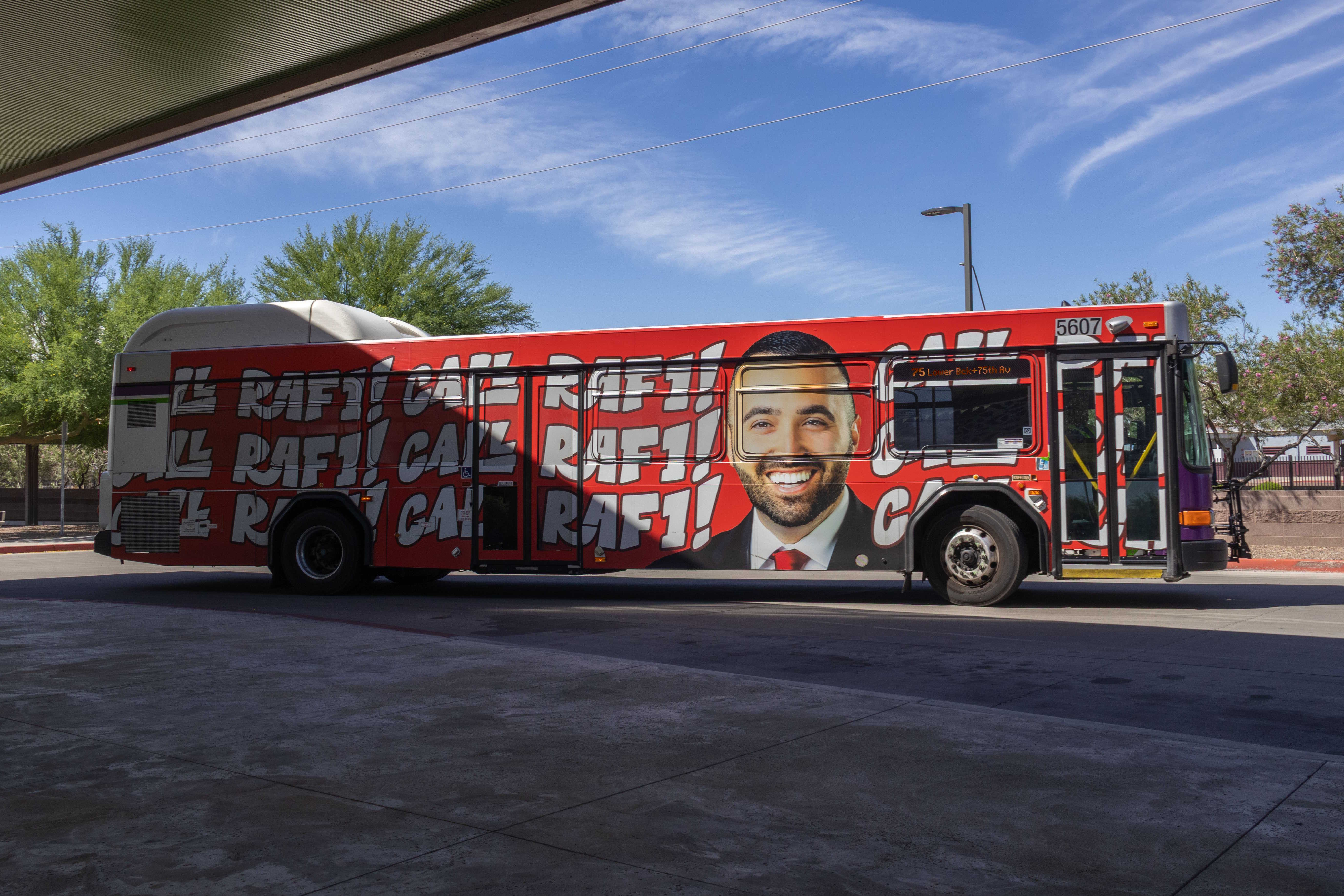 A white and gray Valley Metro bus, with purple and green accent colors, number 5607, at Desert Sky Transit Center in Phoenix on route 75 to 75th Avenue and Lower Buckeye Road