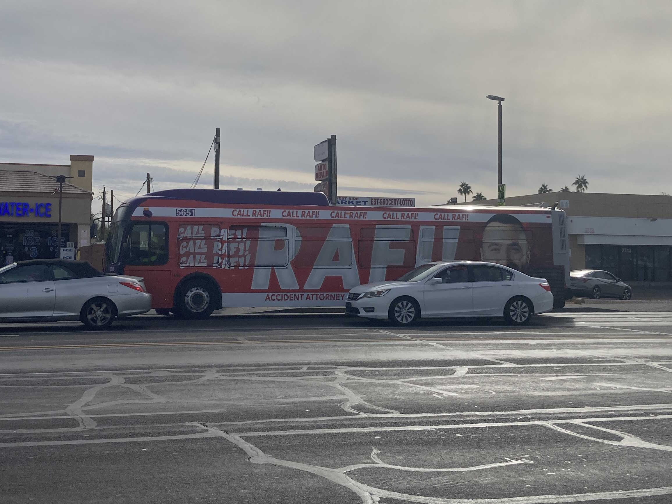 A gray and purple Valley Metro bus, with a green stripe, number 5651, traveling eastbound on Northern Avenue in Phoenix on route 80 to Mustang Transit Center