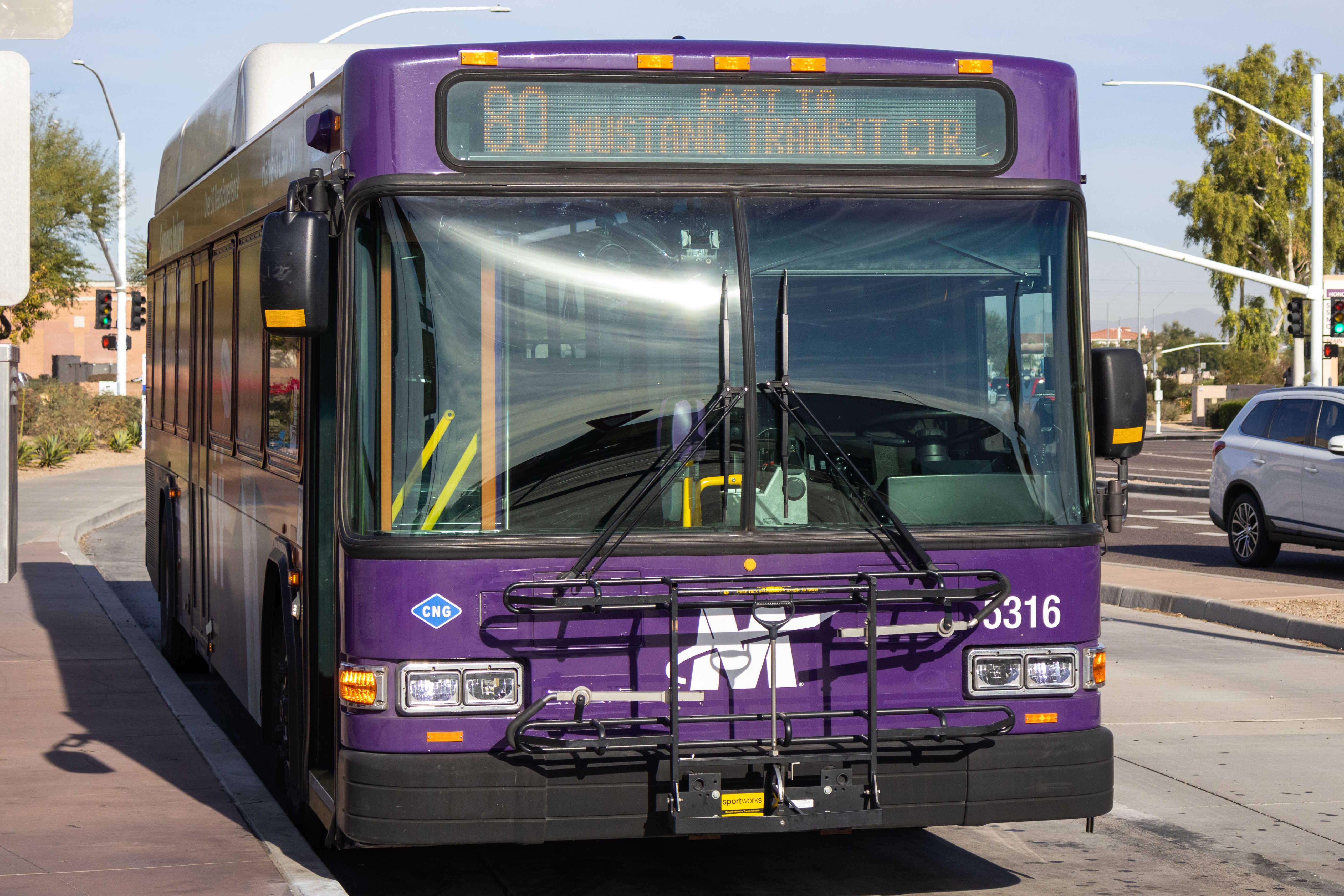 A gray and purple Valley Metro bus, with a green stripe, number 5316, at Mustang Transit Center in Scottsdale on route 80 to Mustang Transit Center