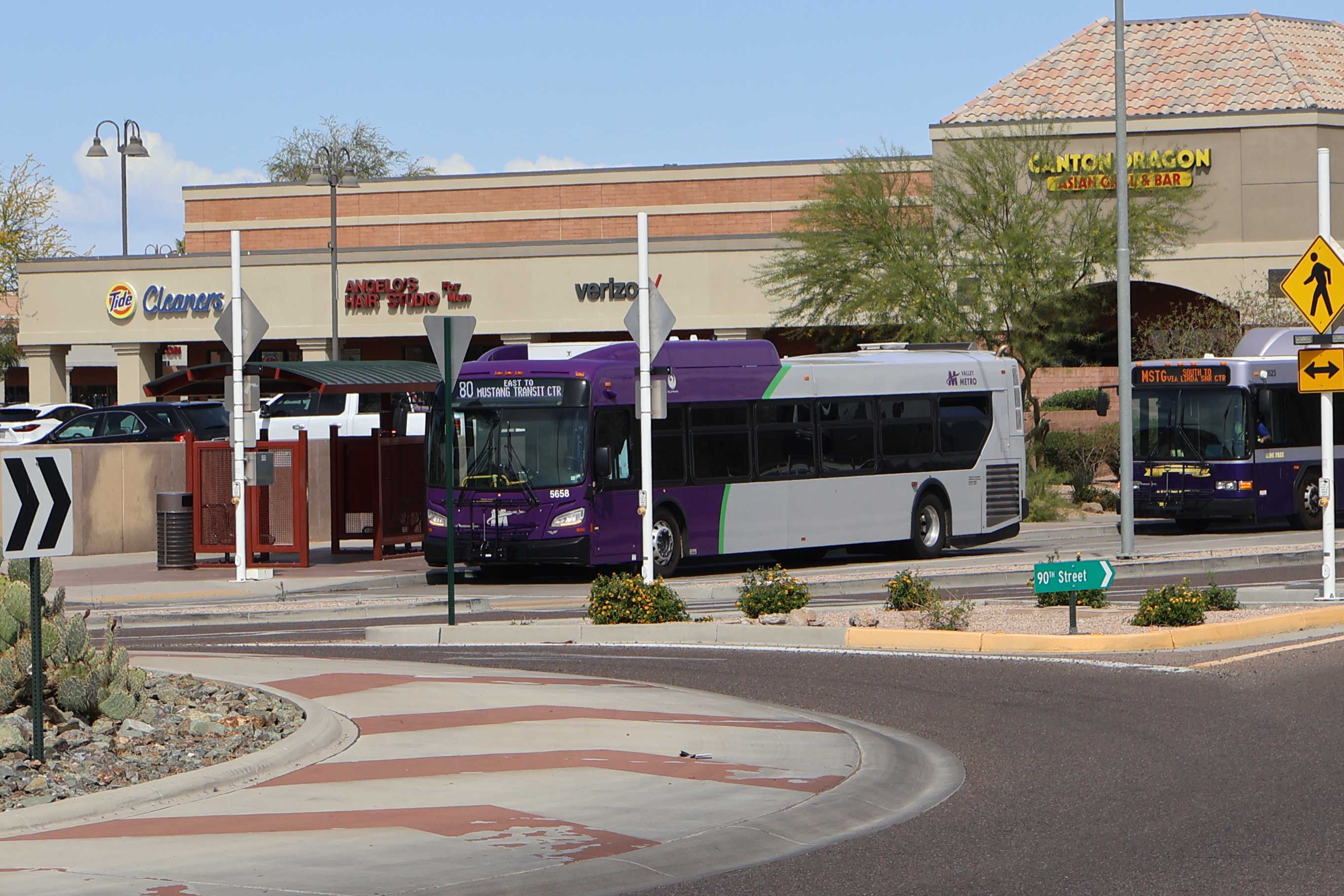A purple and gray Valley Metro bus, with a green stripe, number 5658, at Mustang Transit Center in Scottsdale on route 80 to Mustang Transit Center