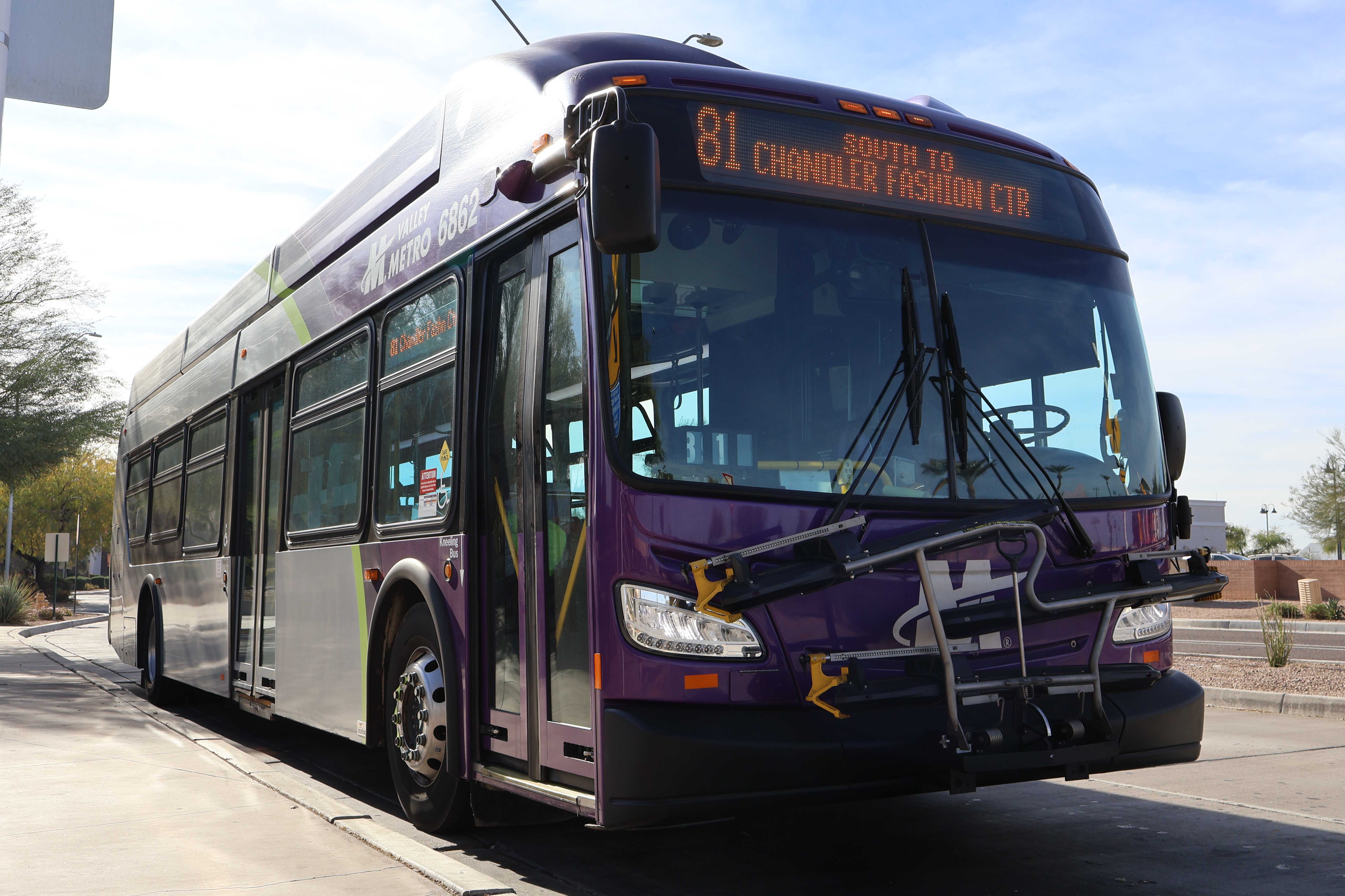 A gray and purple Valley Metro bus with a green stripe, number 6862, at Mustang Transit Center in Scottsdale on route 81 to Chandler Fashion Center