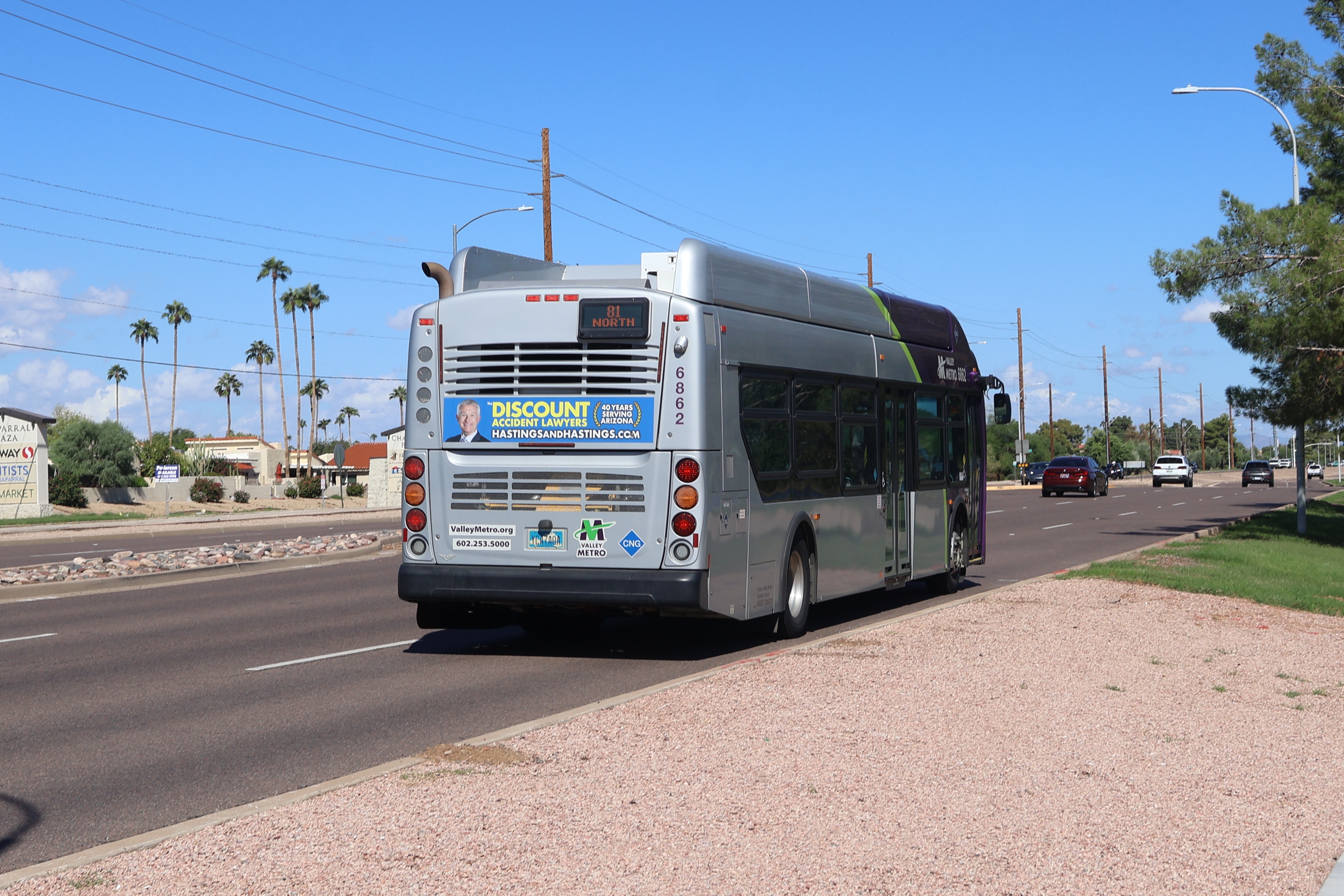 A gray and purple Valley Metro bus with a green stripe, number 6862, traveling northbound on Hayden Road in Scottsdale on route 81 to Mustang Transit Center